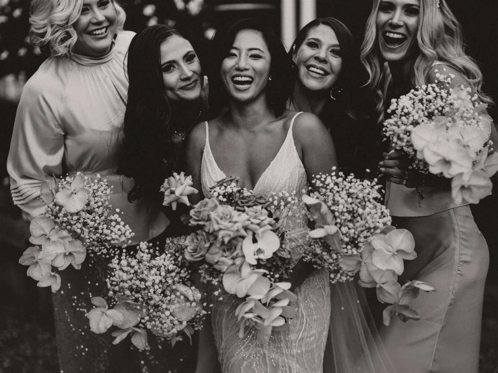 Bride and bridesmaids laughing