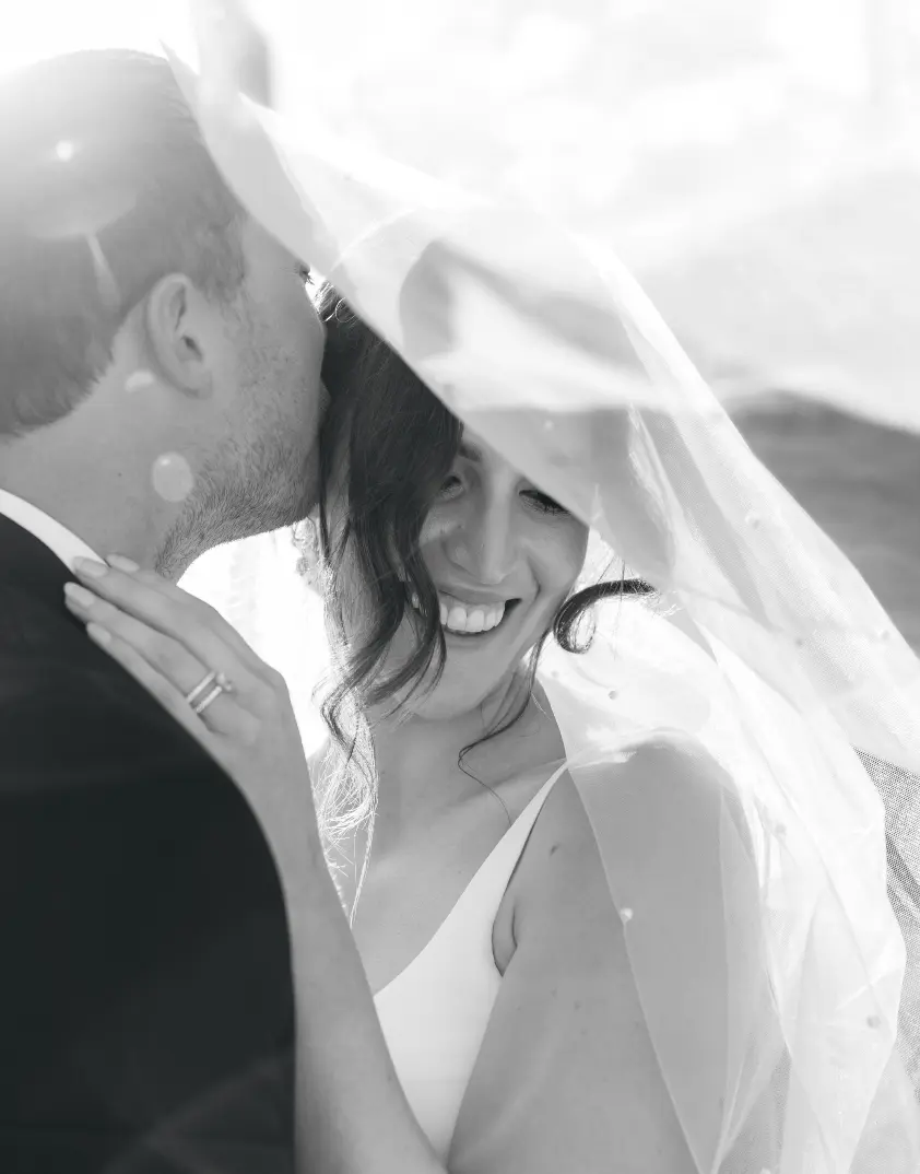 Couple pose under veil