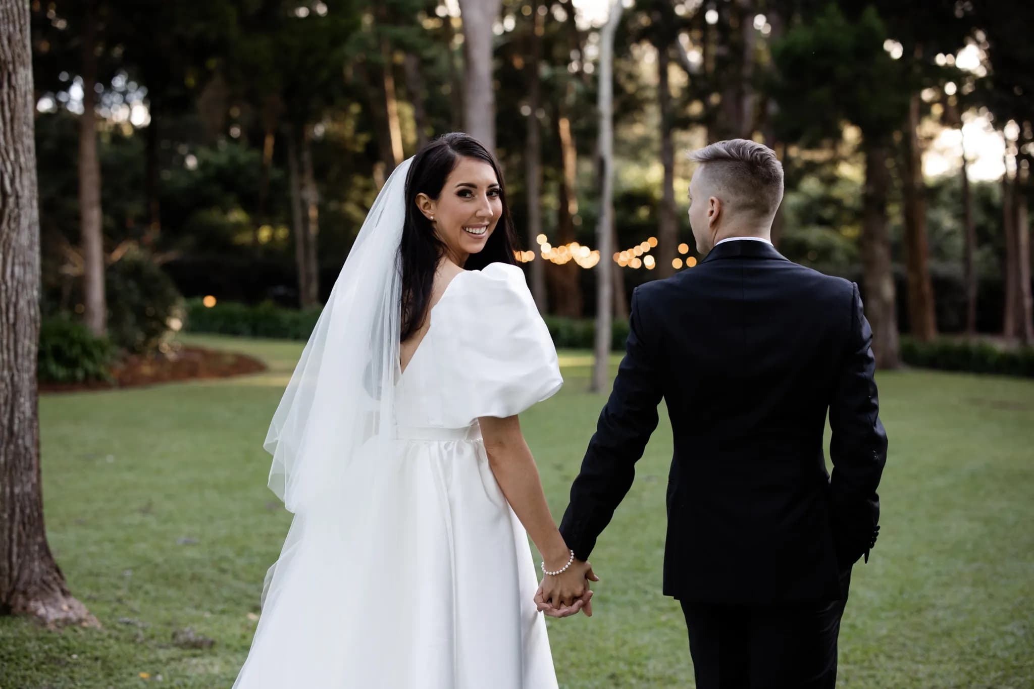 Bride and groom walking holding hands