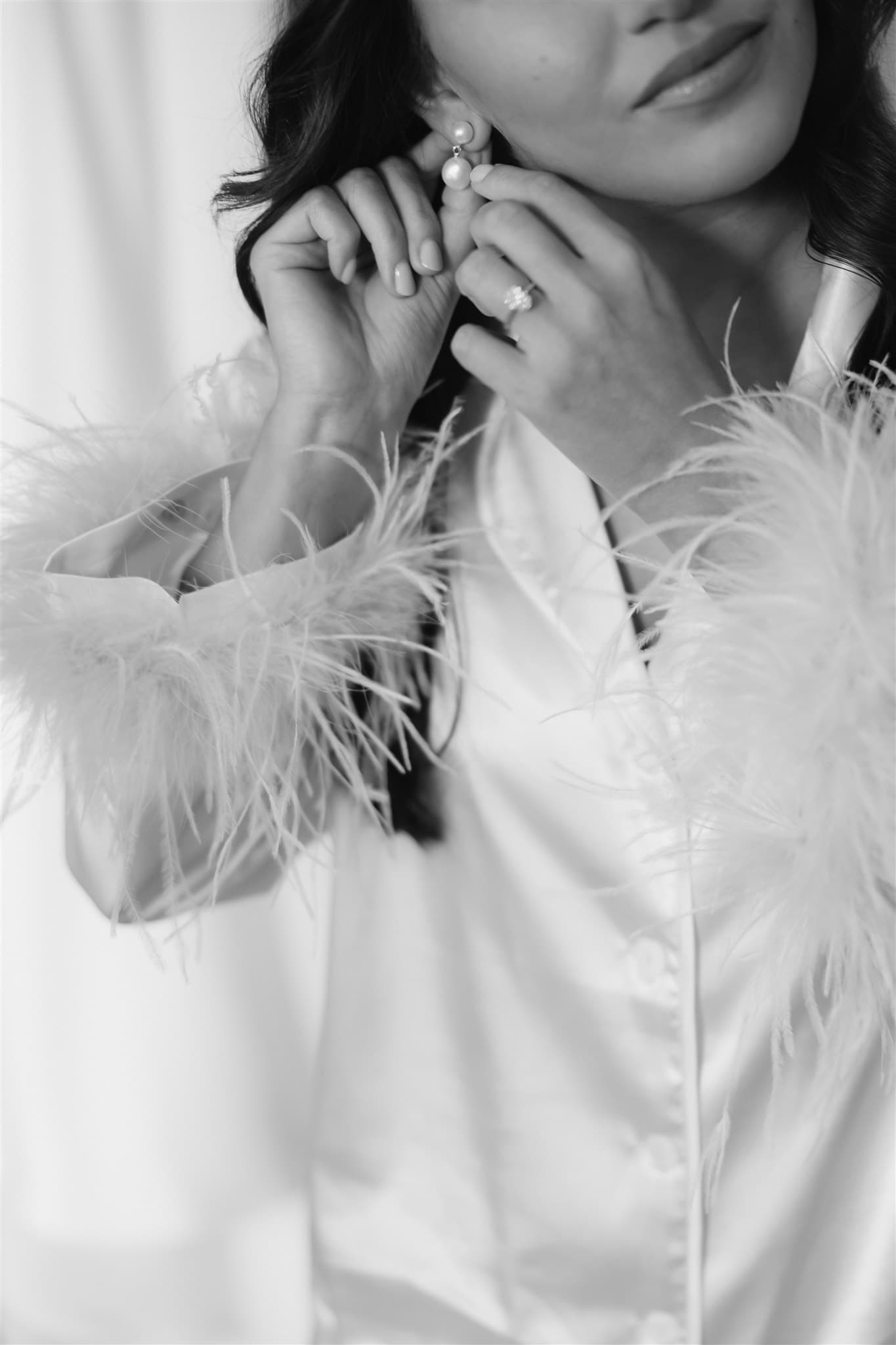 Bride putting in earrings