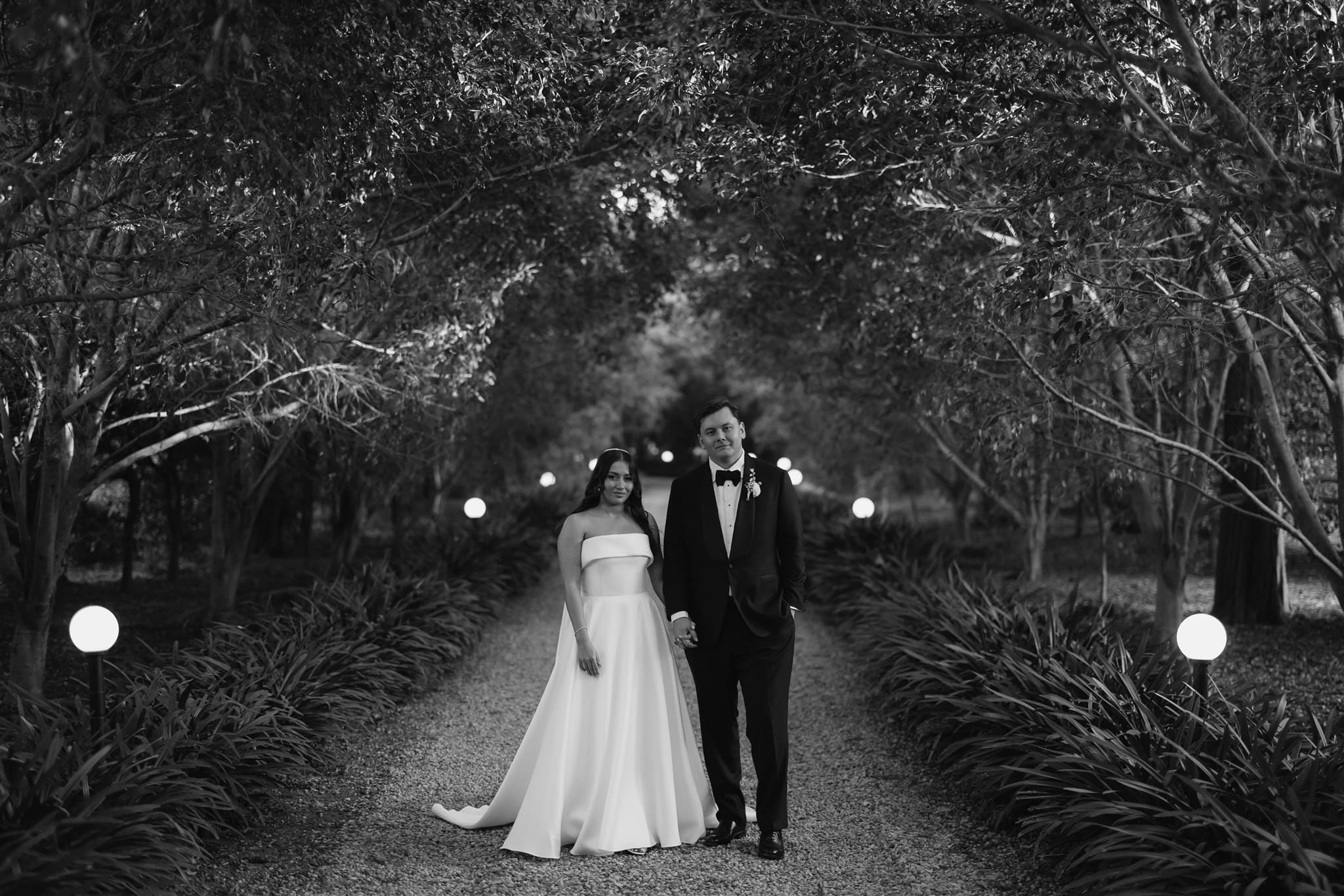 Bride and groom standing on driveway