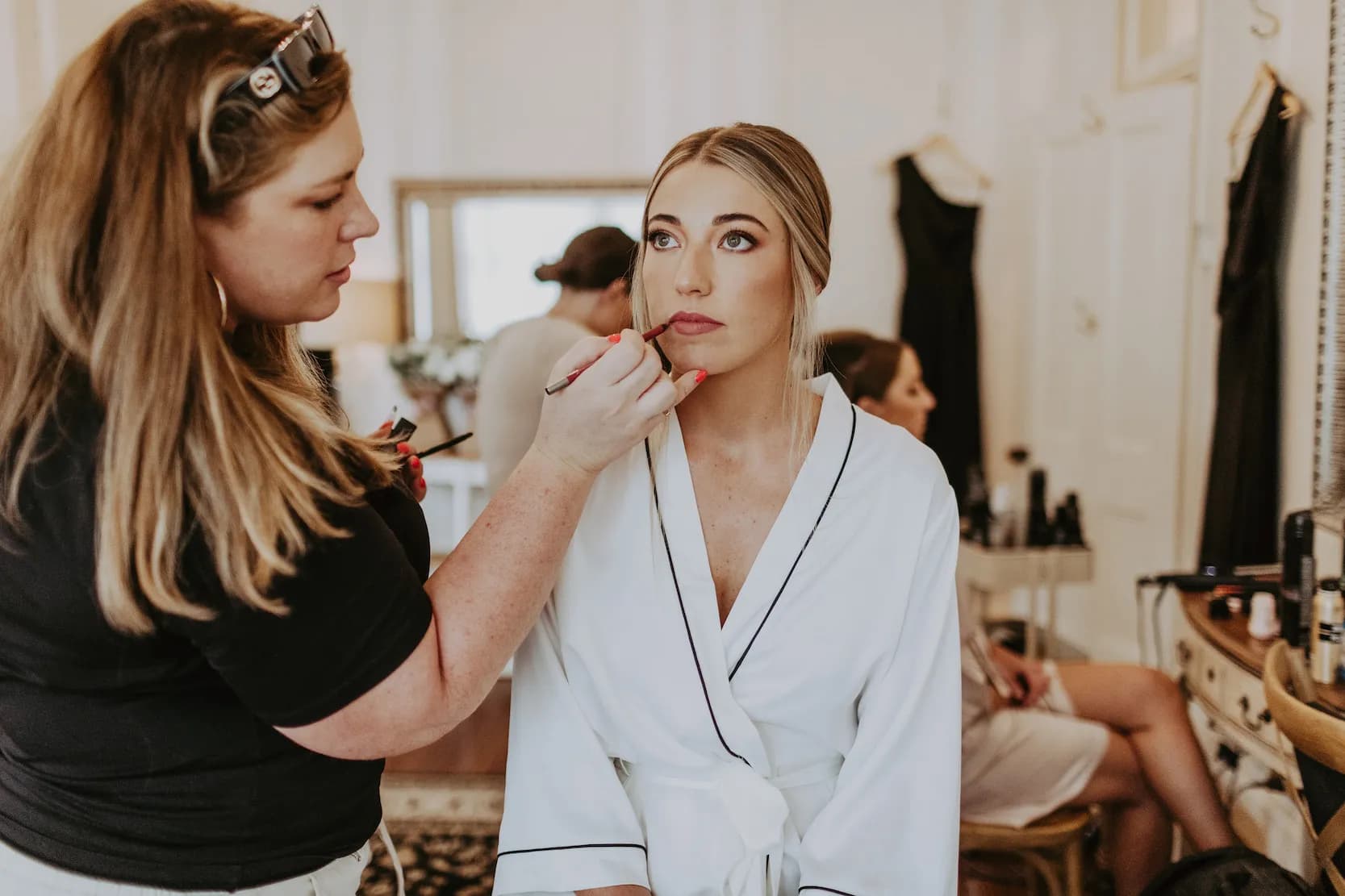 Bride getting makeup applied to her eyes