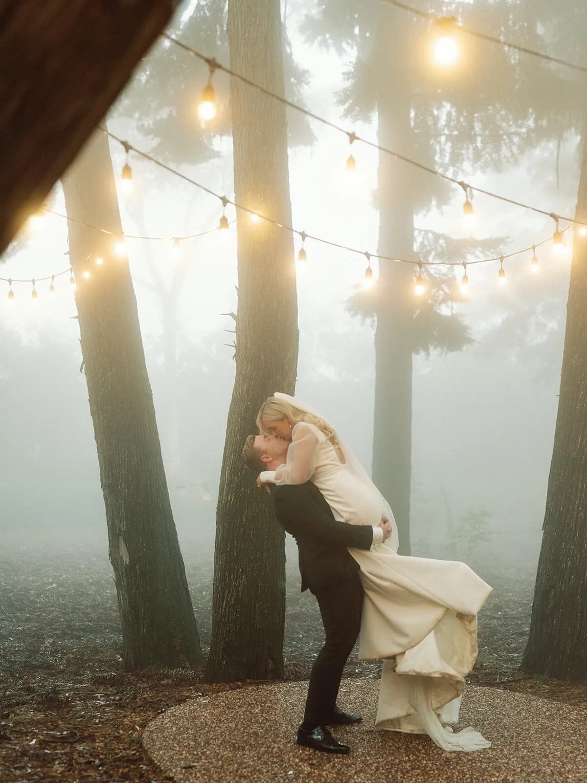 Bride and groom kissing and dancing