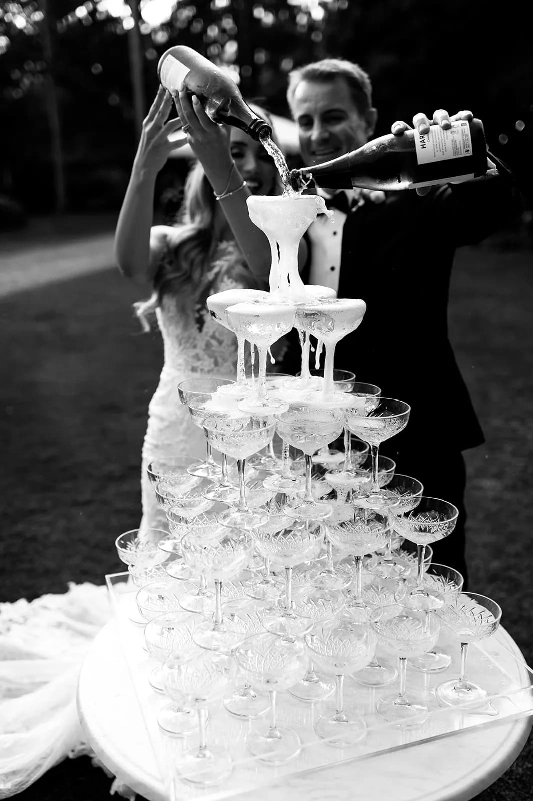 Bride and groom pouring champagne tower