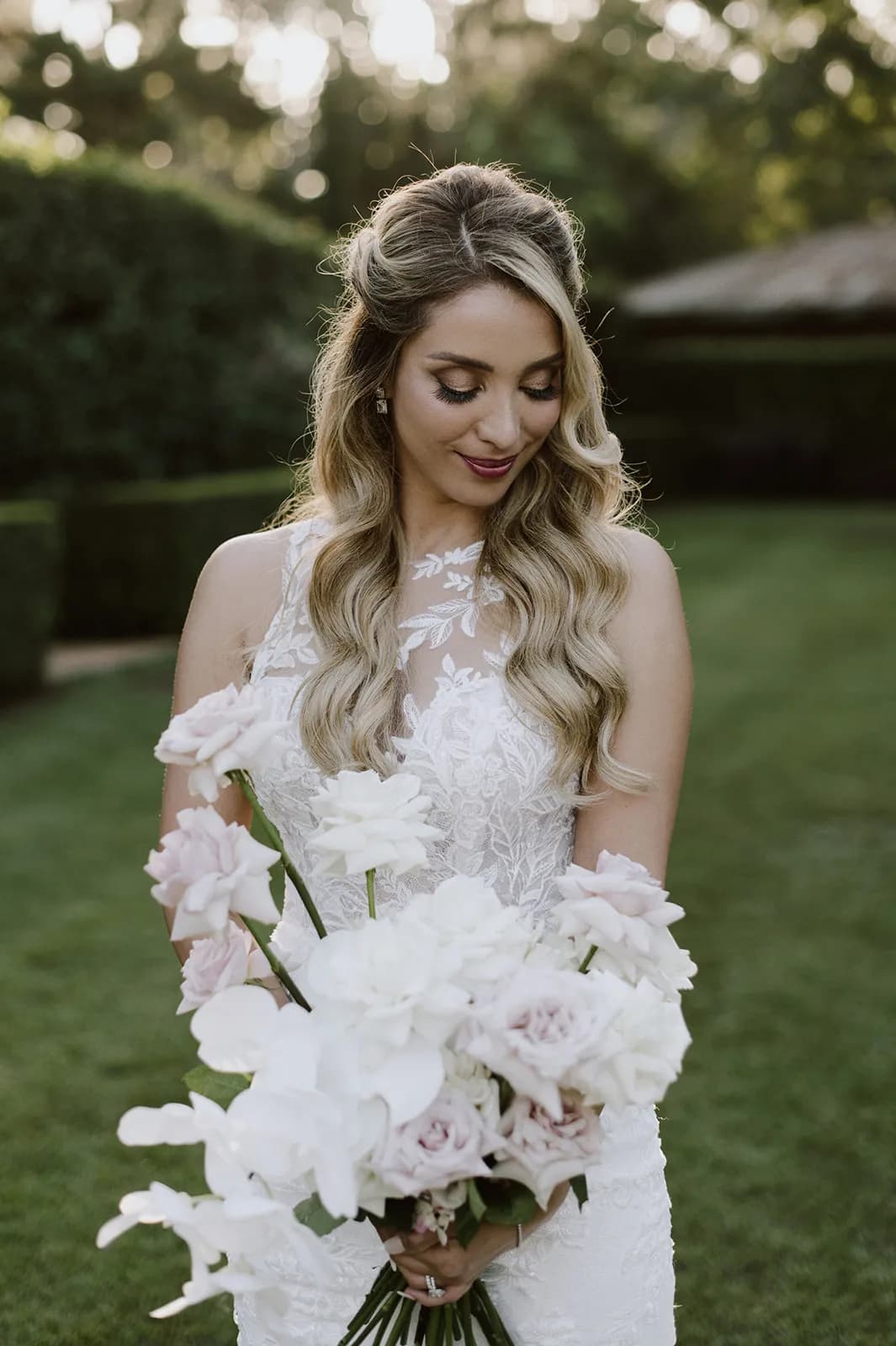 Bride looking at flowers
