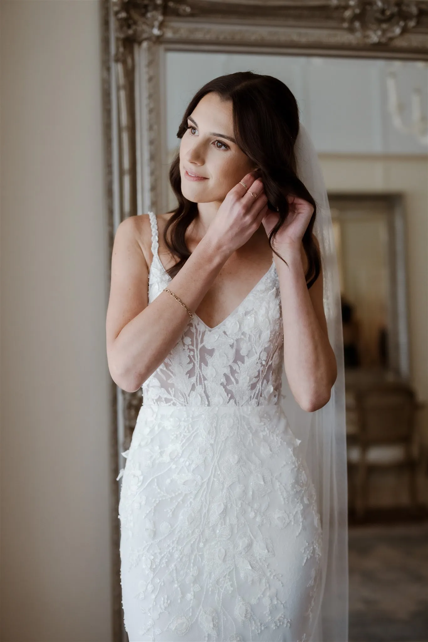 Bride putting in earring