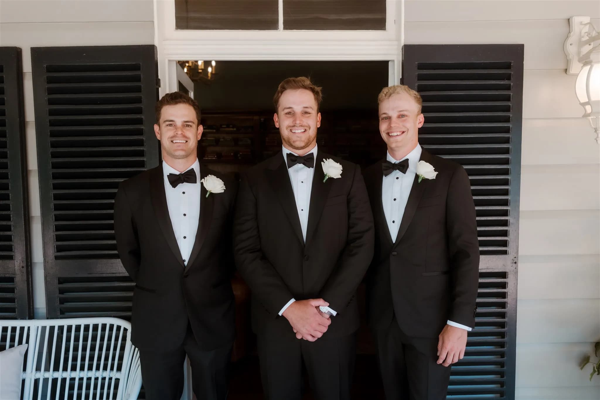 Groom and groomsemn standing together smiling