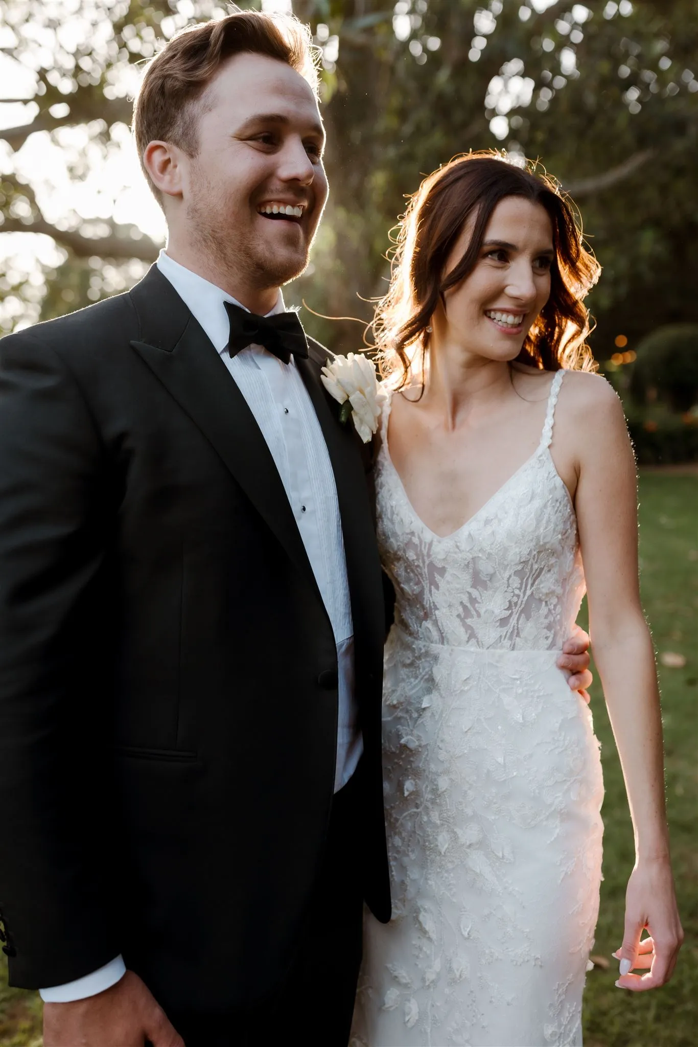 Bride and groom laughing and embracing