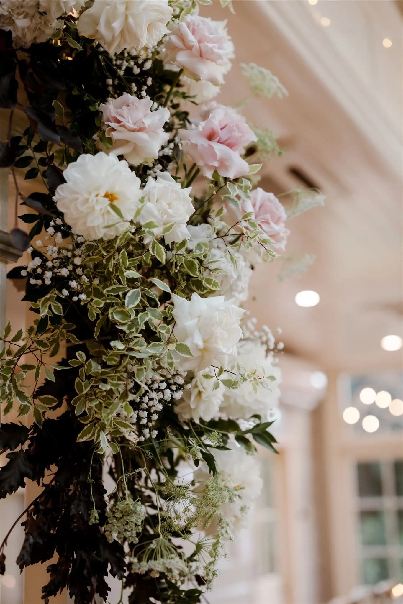 Flowers mounted on pole in wedding reception