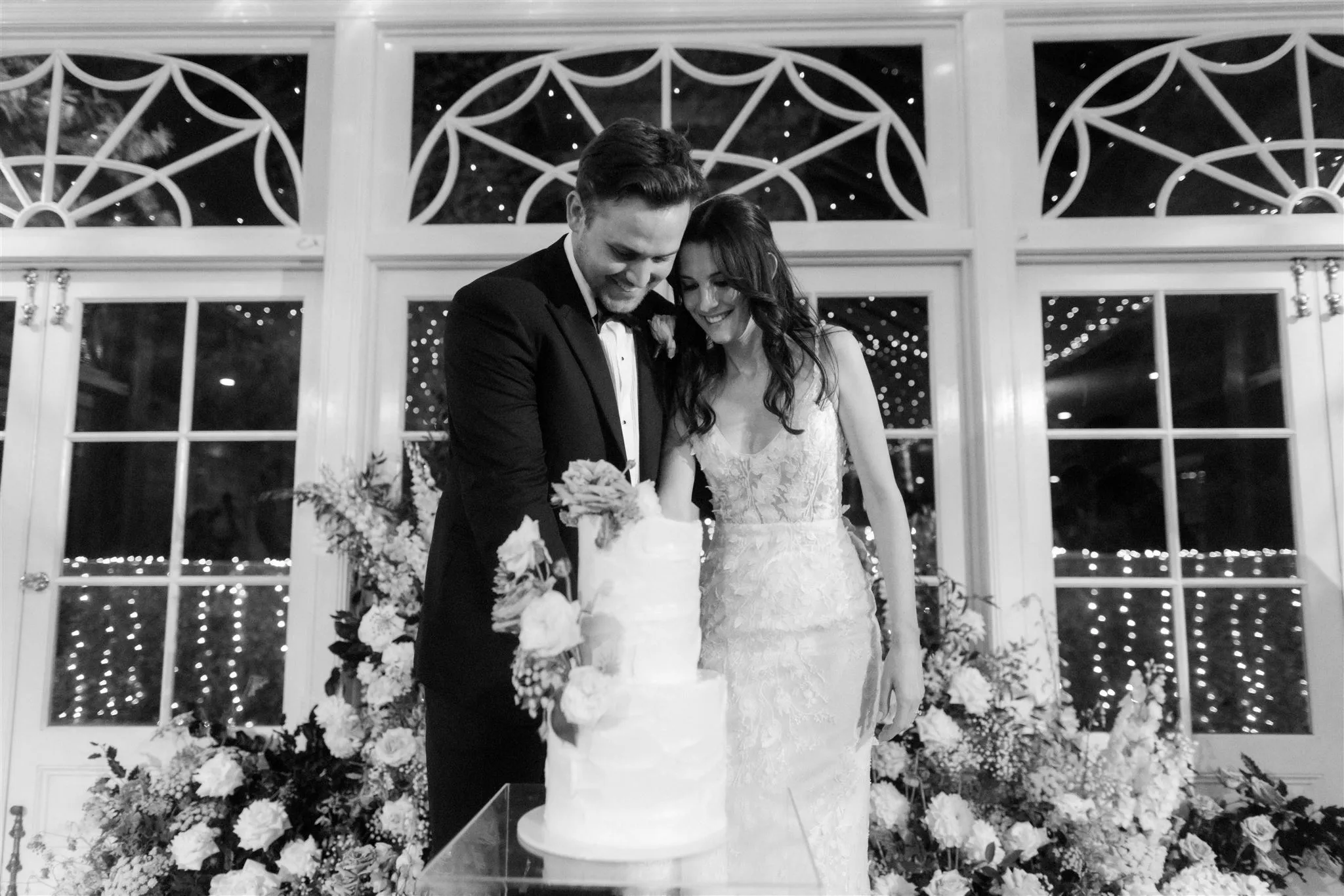 Bride and groom cutting wedding cake
