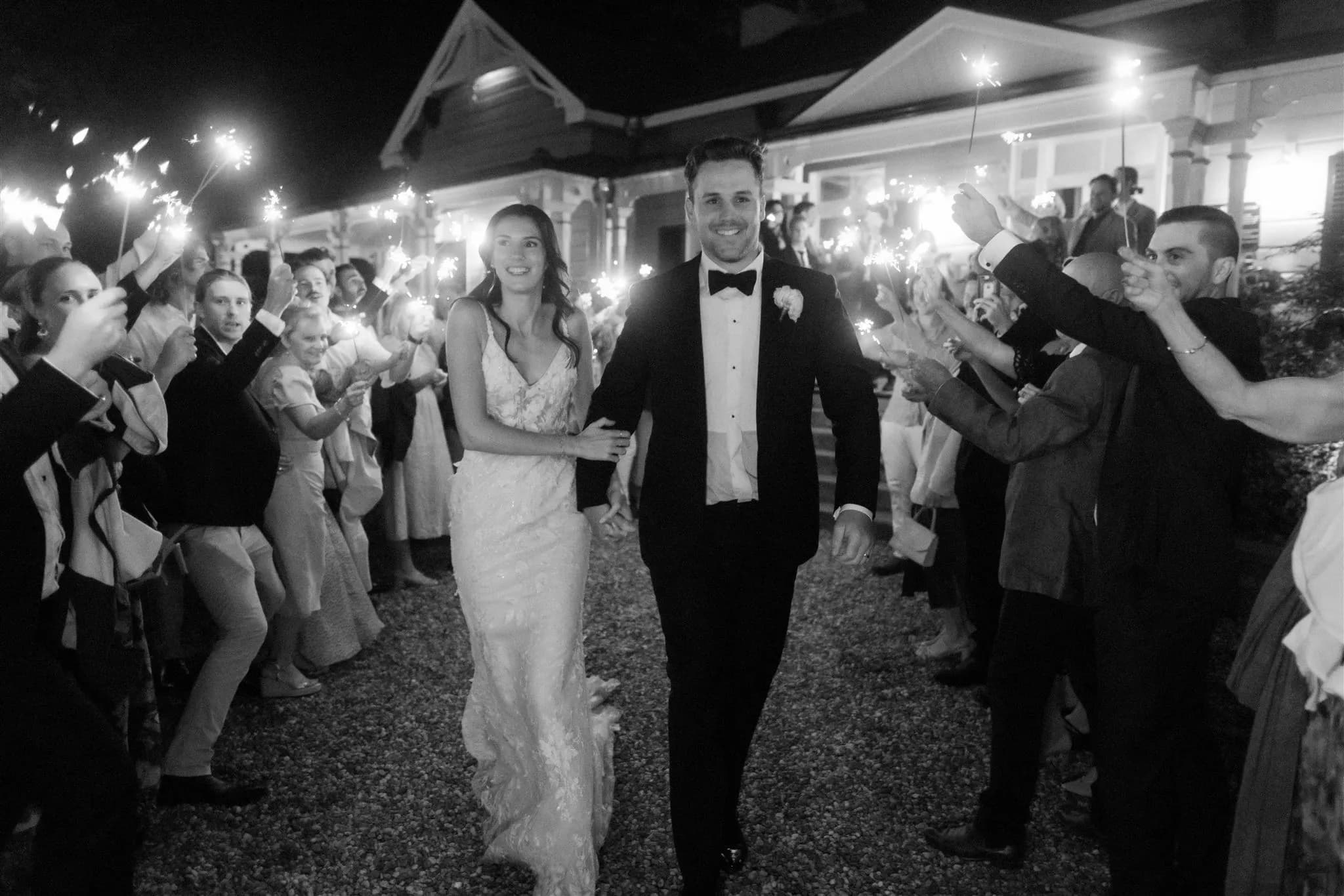 Bride and groom walking past guests with sparklers