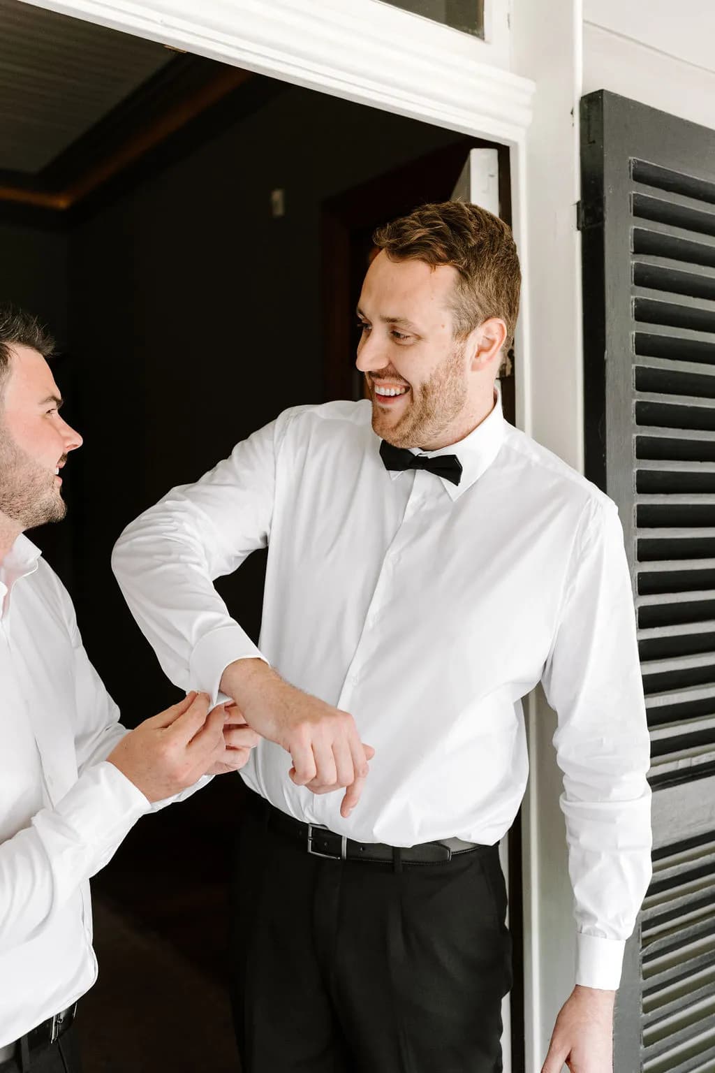 Groom doing up cufflinks