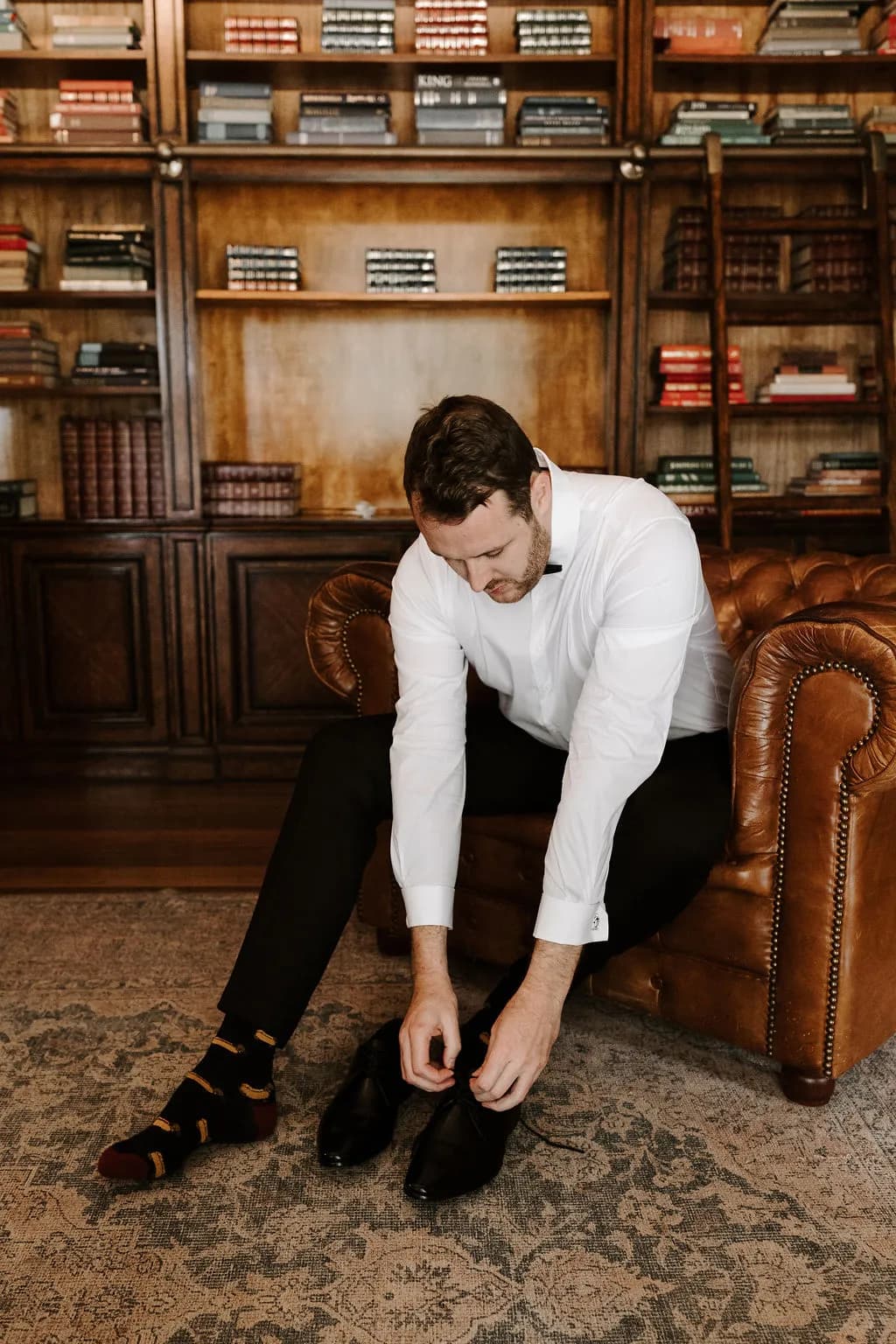 Groom doing up shoe laces