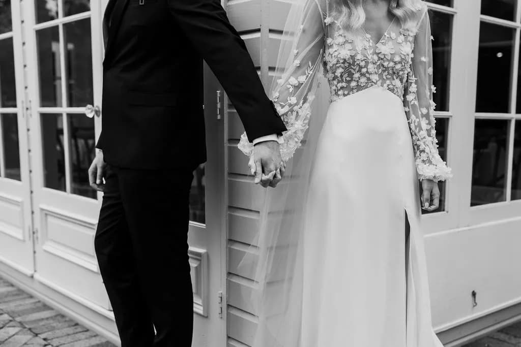 Bride and groom holding hands