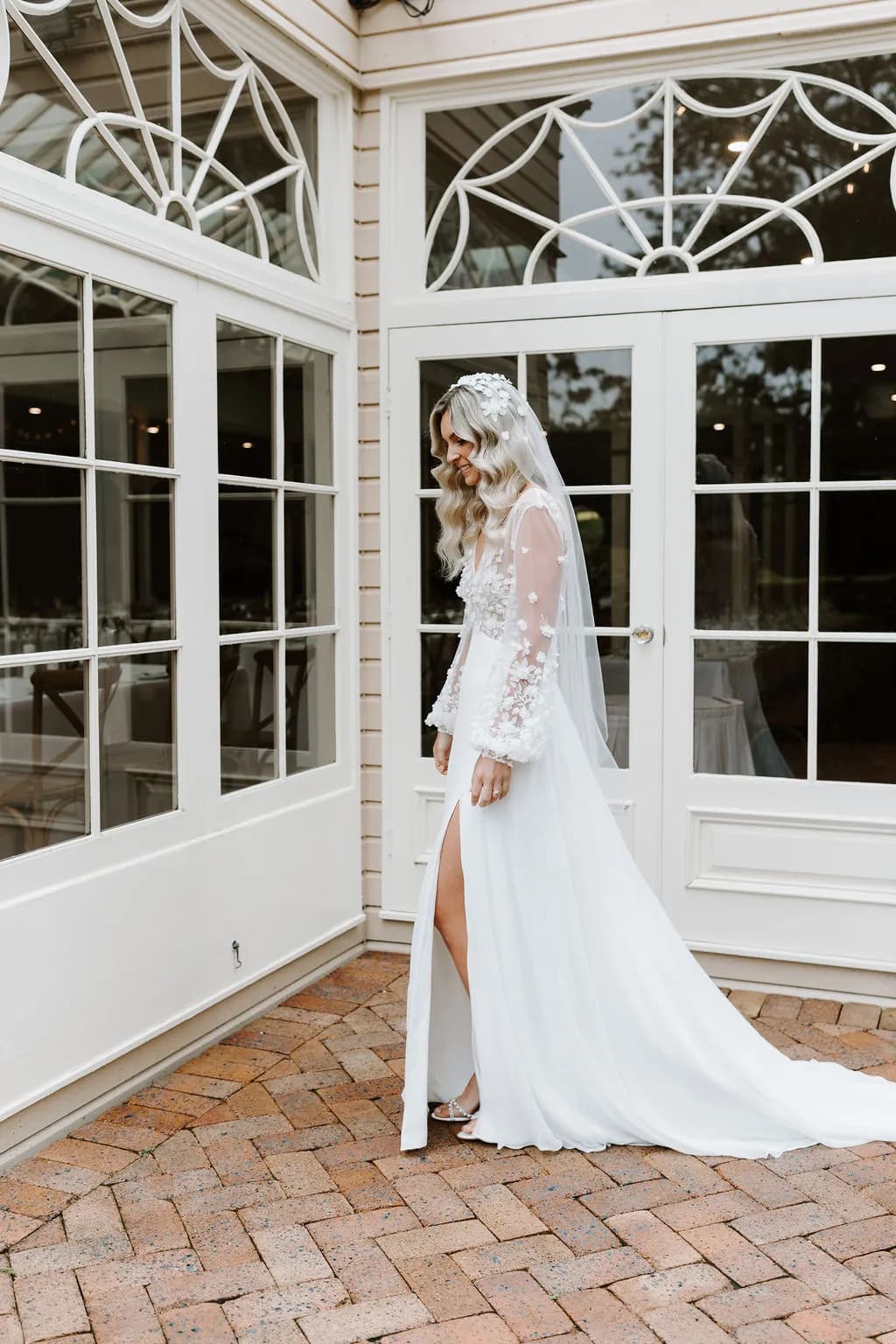 Bride standing in courtyard