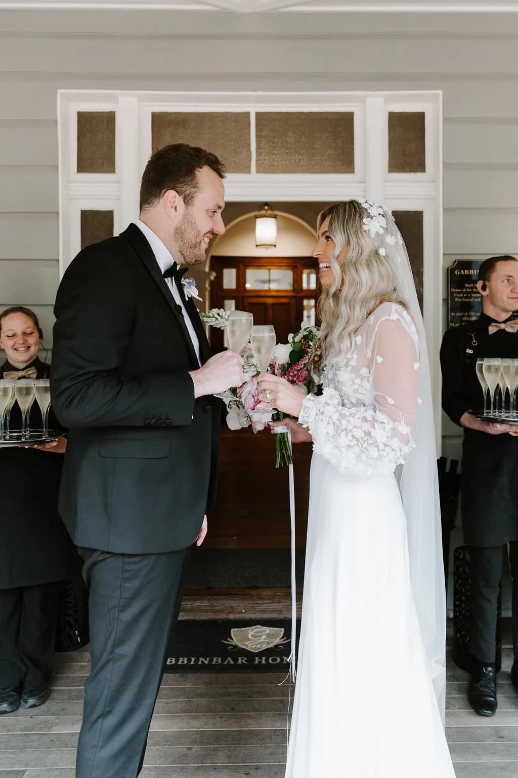 Bride and groom standing in front of door