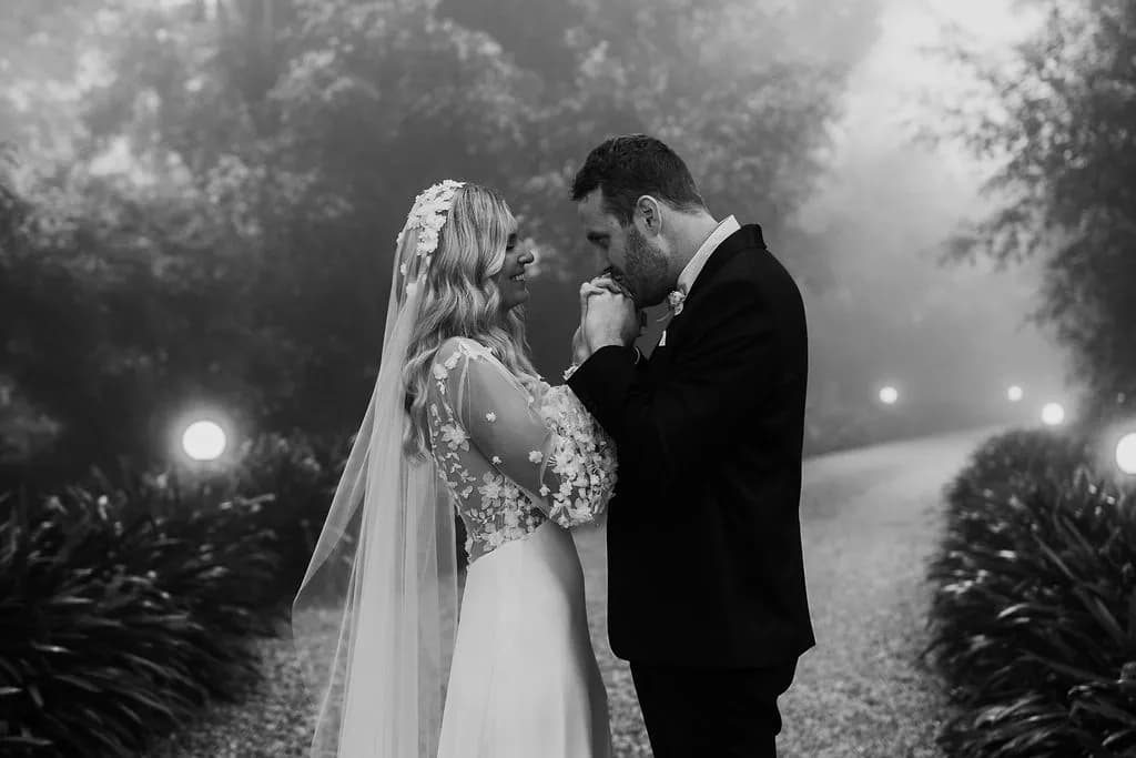 Groom kissing brides hands