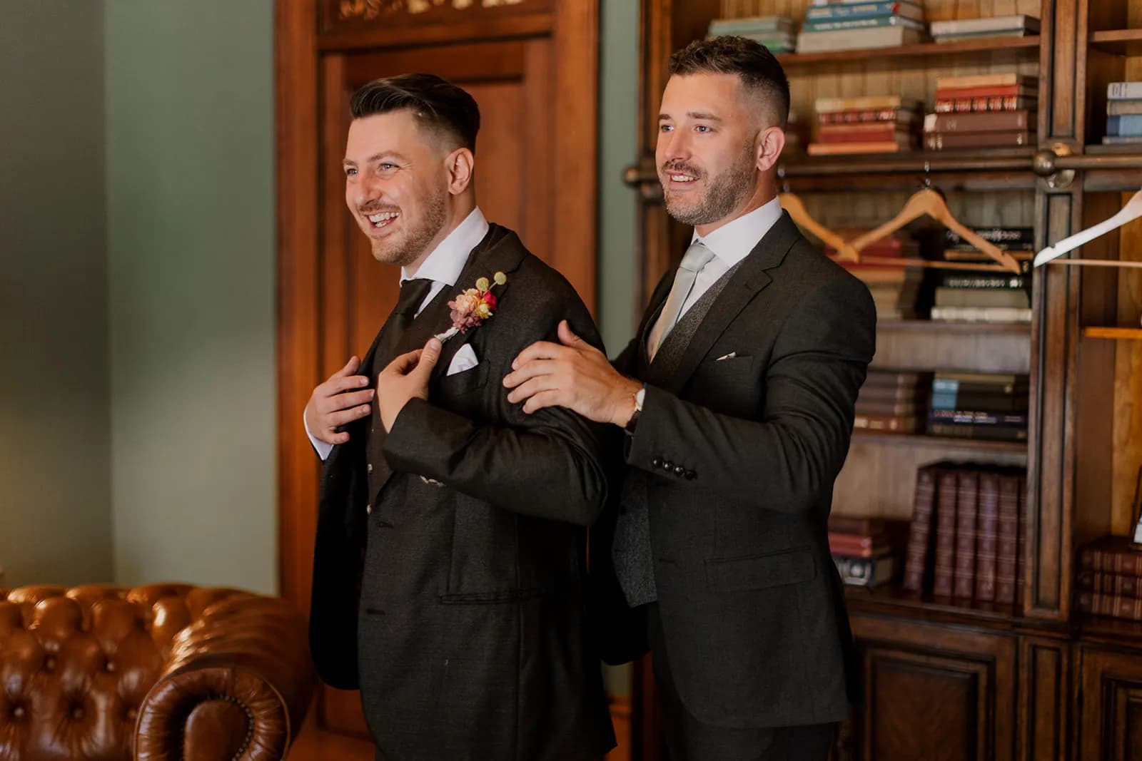 Groom putting jacket on
