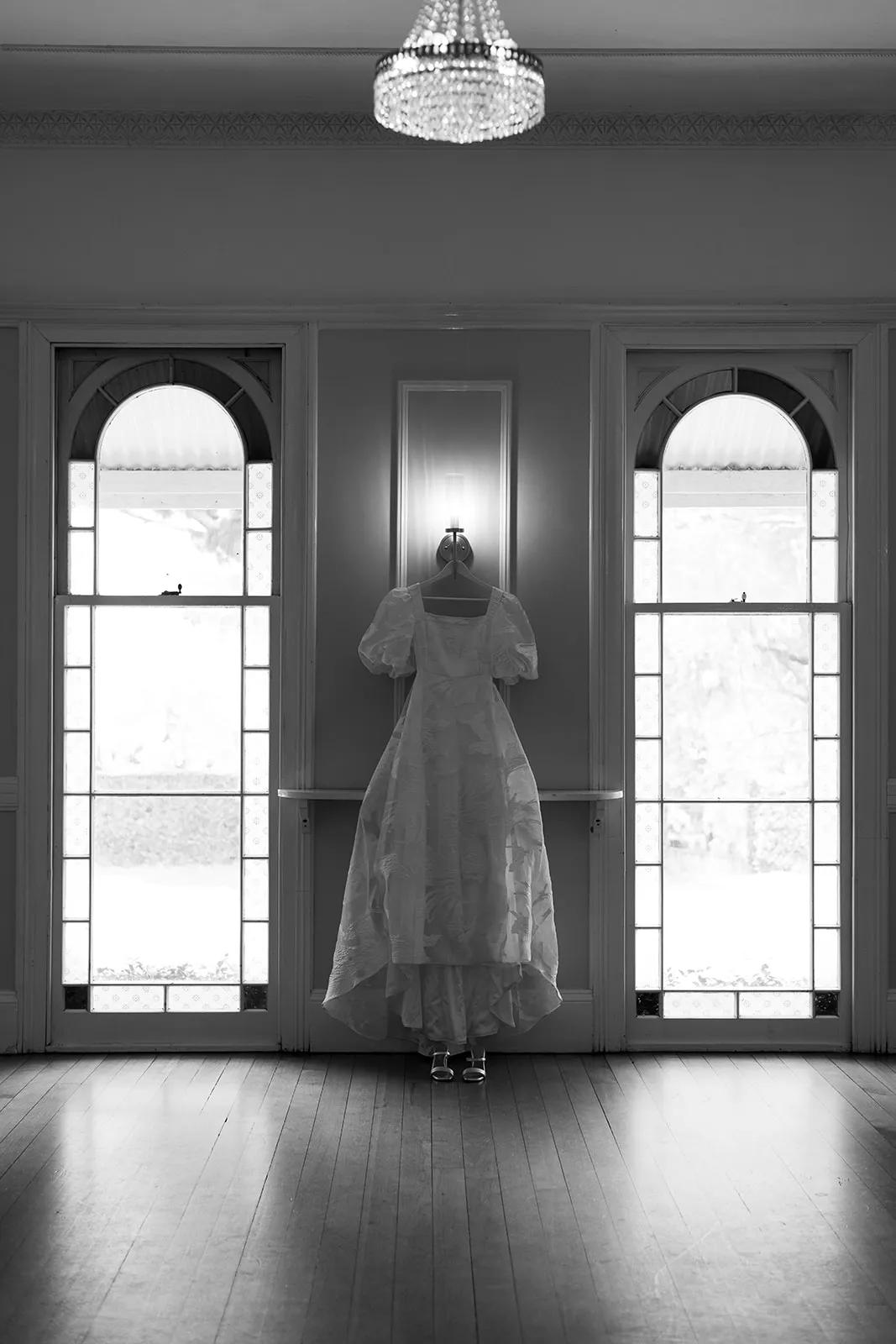 Weddign dress hanging in ballroom