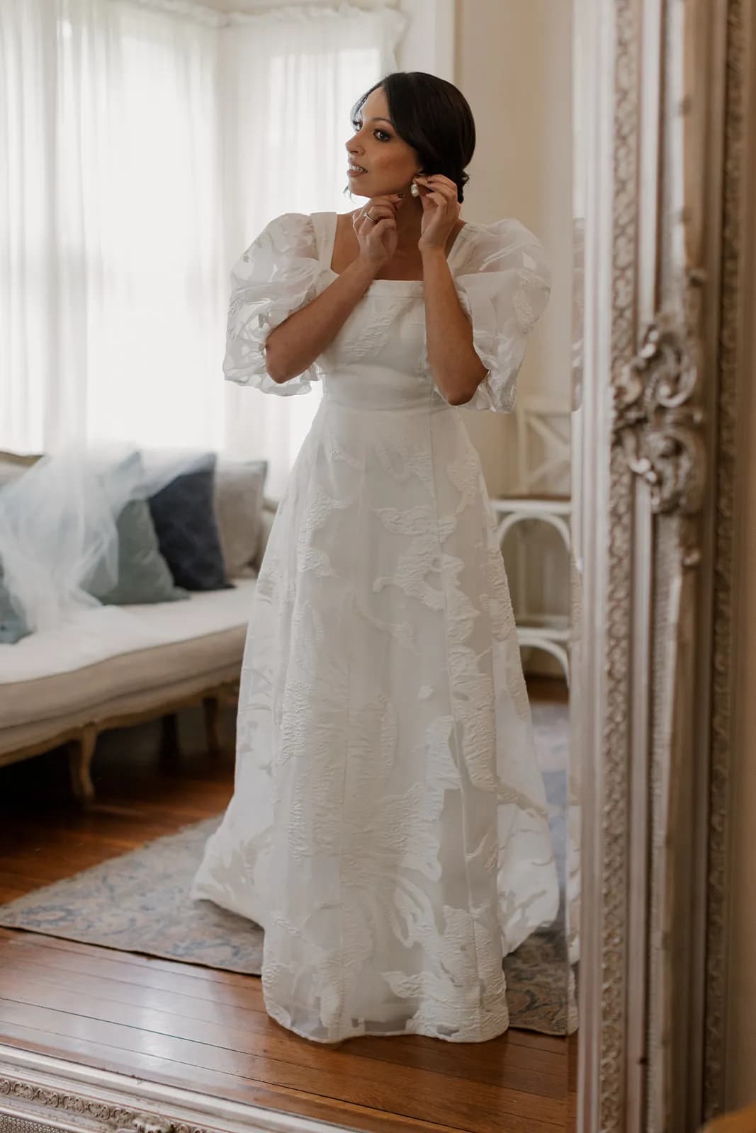 Bride putting earrings in