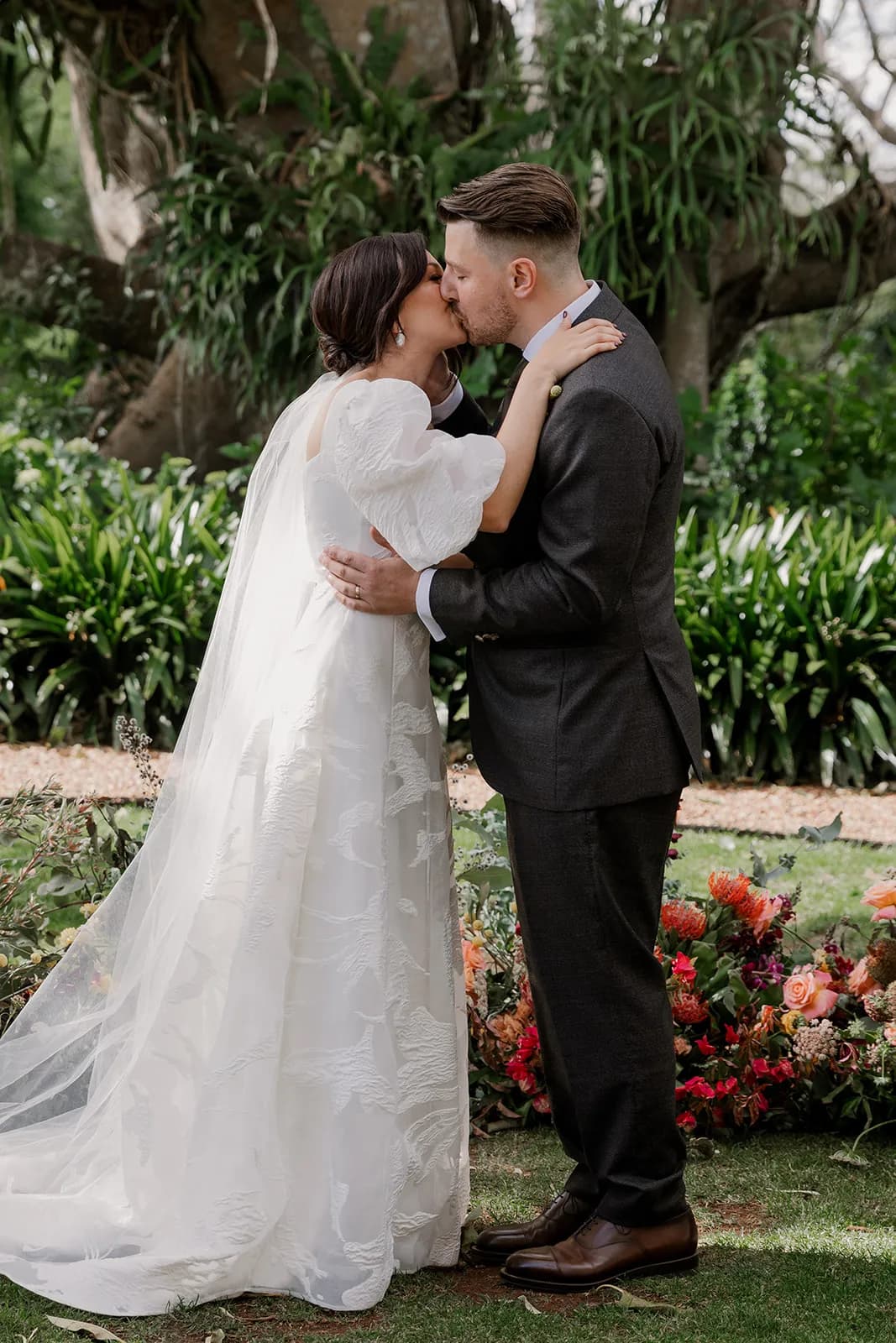Bride and groom kissing at aisle