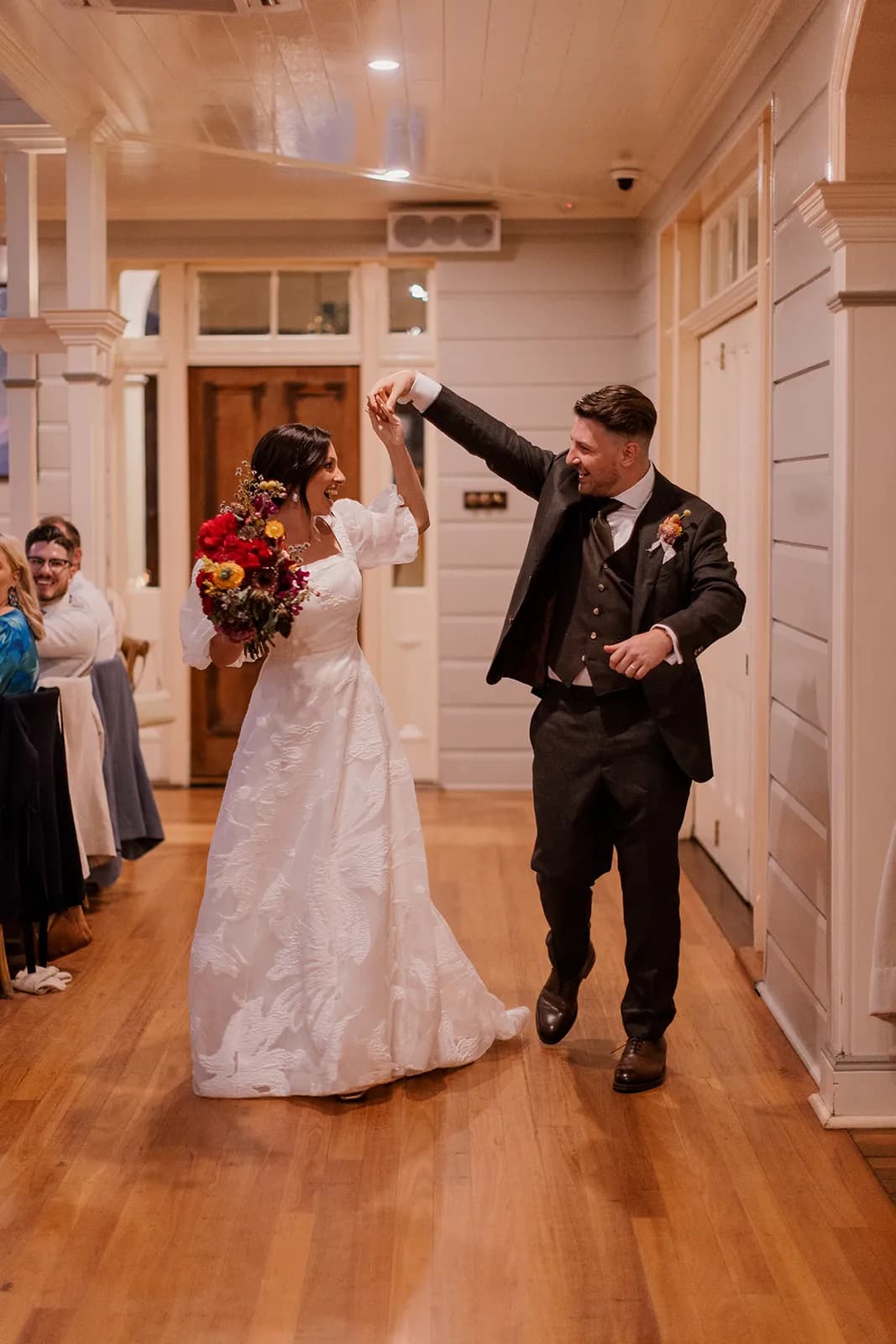 Bride and groom entering reception