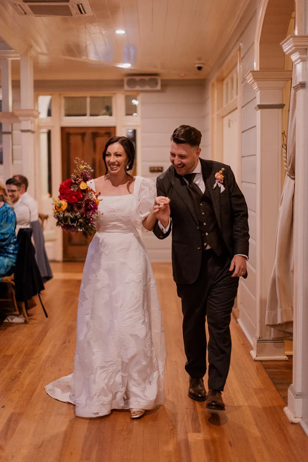 Bride and groom entering reception