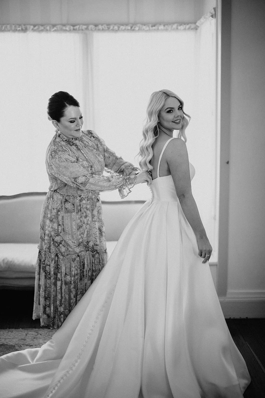 Mother of Bride doing up dress