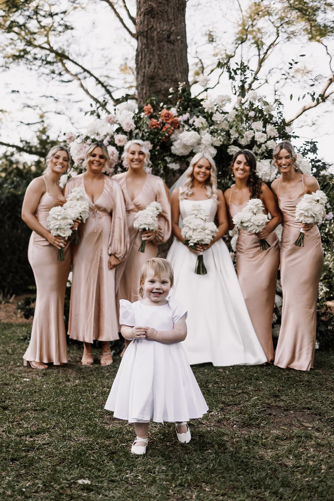Bride and bridesmaids with flower girl