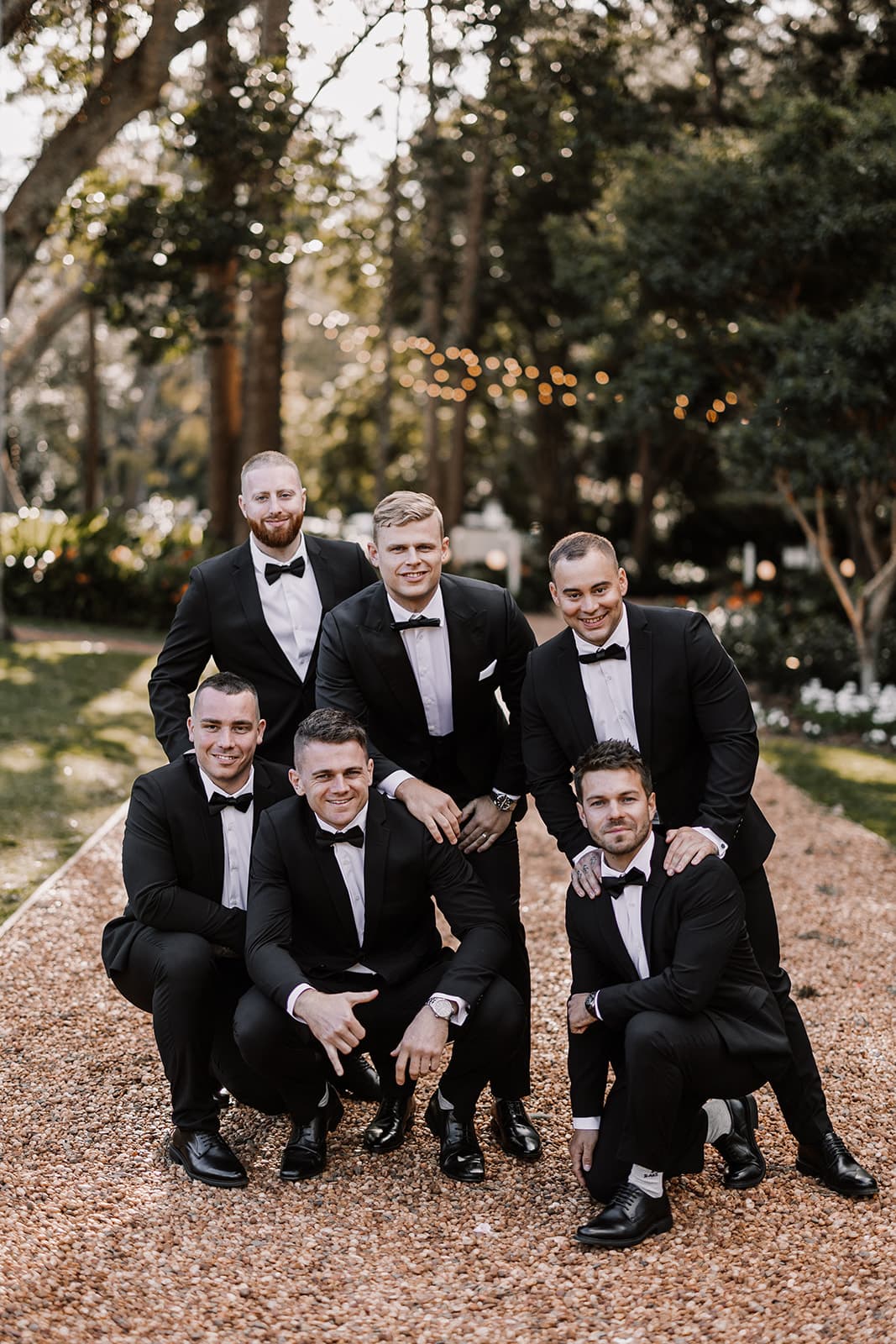 Grom and groomsmen standing on driveway