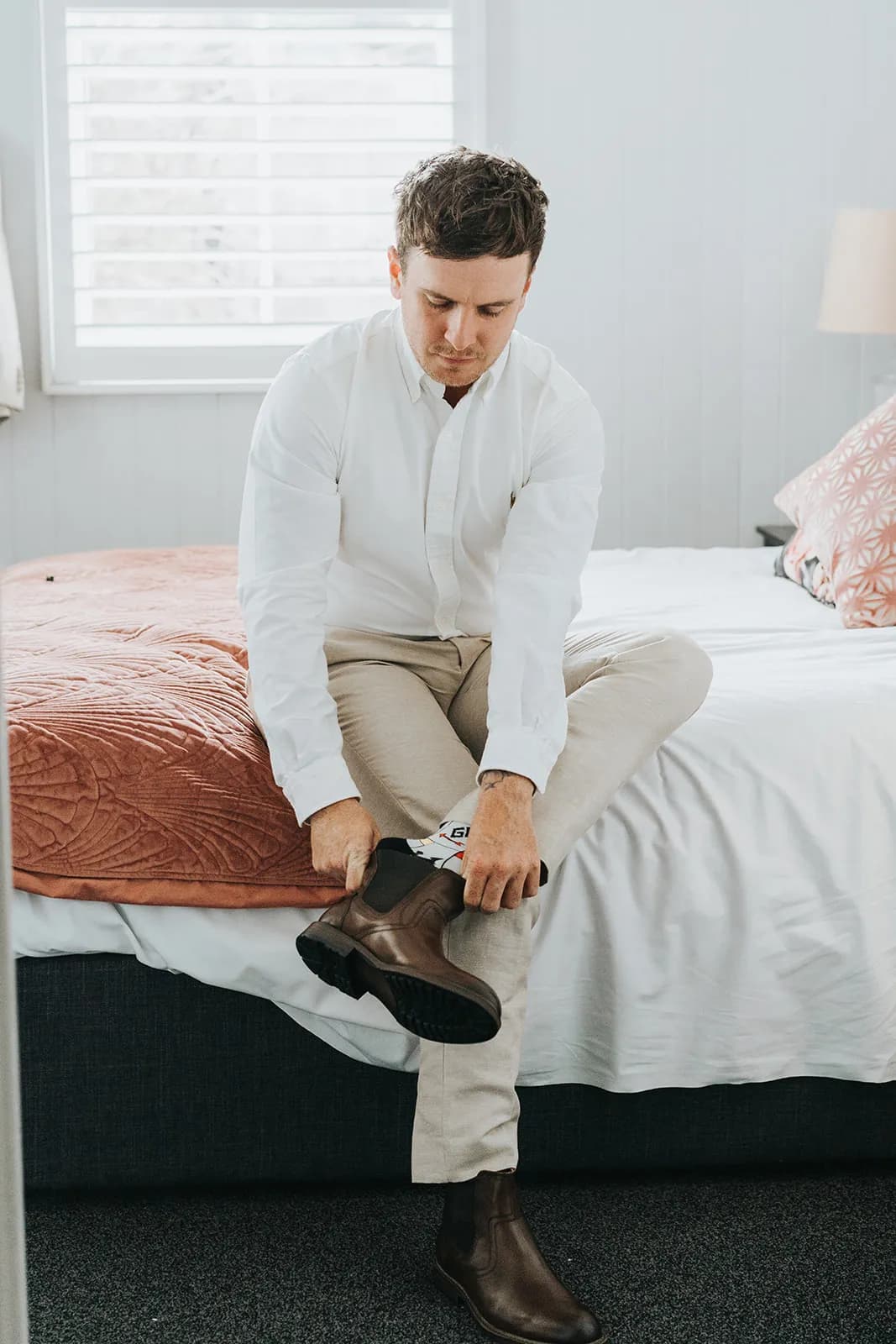 Groom putting on boots