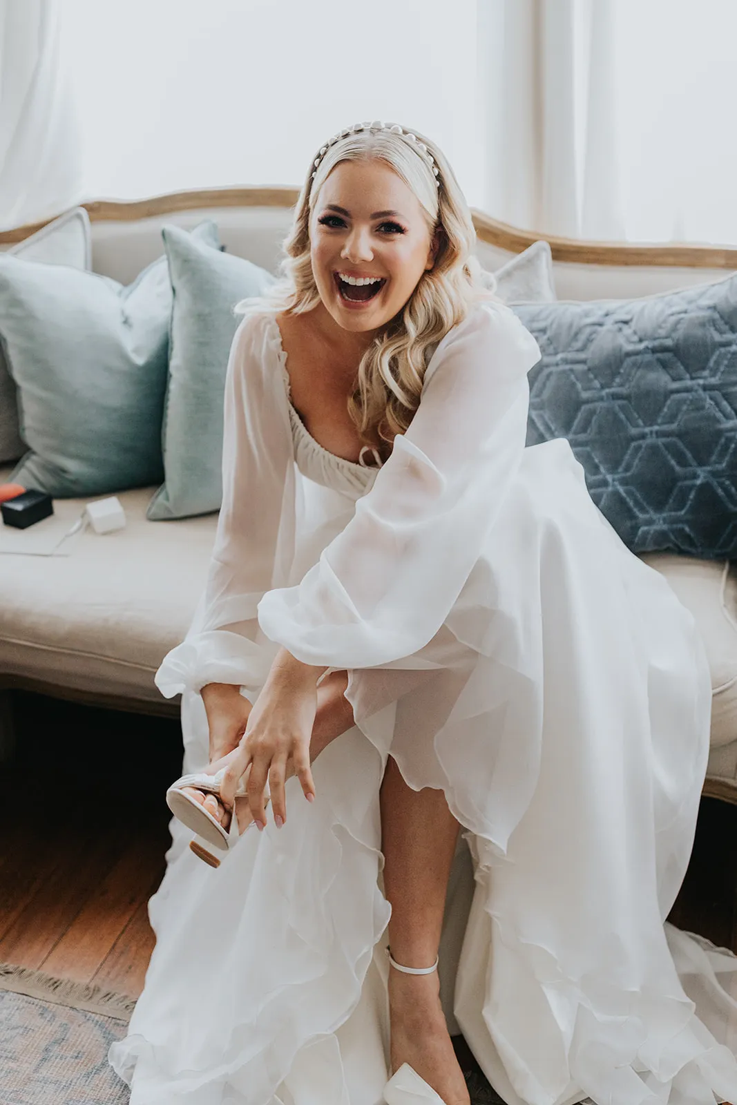 Bride putting shoes on