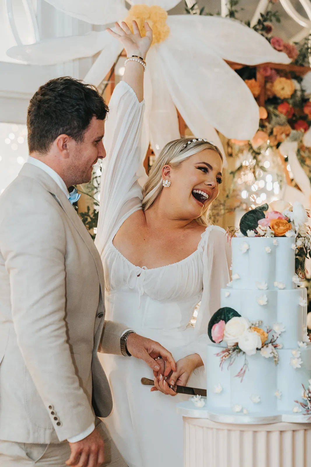 Bride and groom cutting wedding cake
