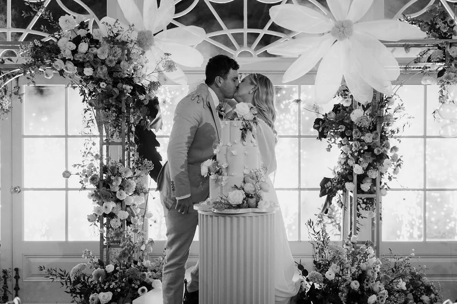 Bride and groom kissing in front of fireworks