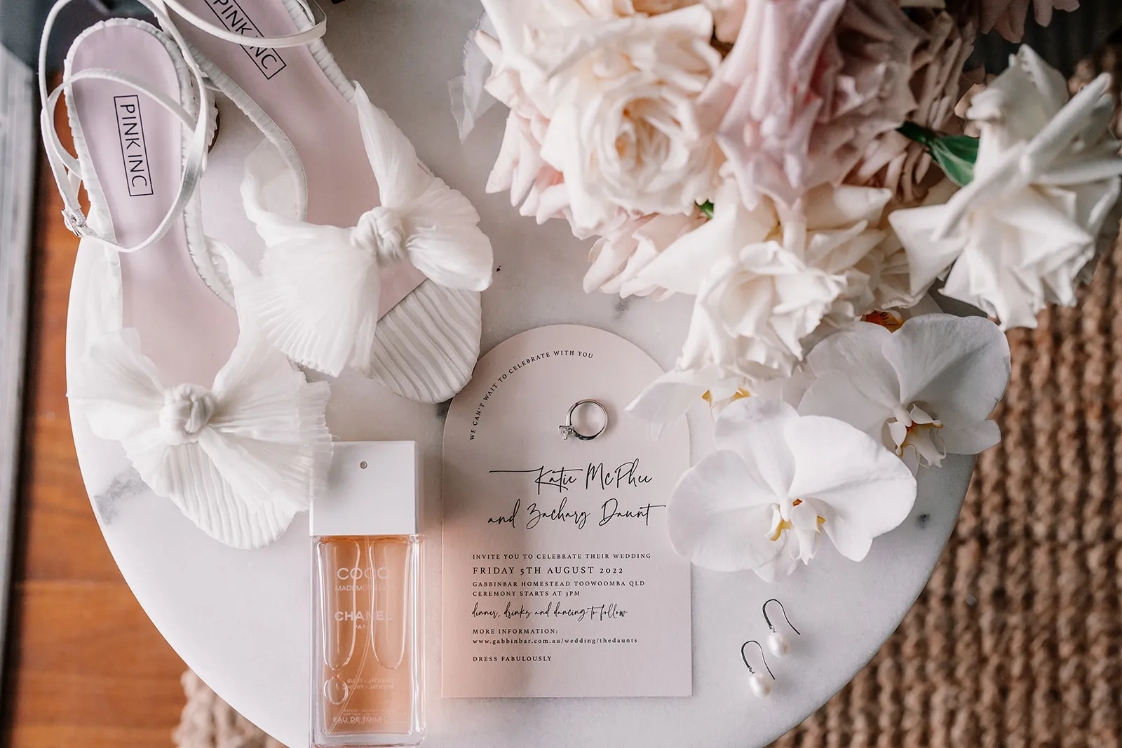 Brides shoes and flowers and rings and invitations
