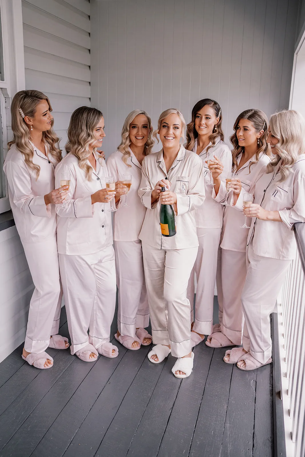 Bride and bridesmaid drinking champagne