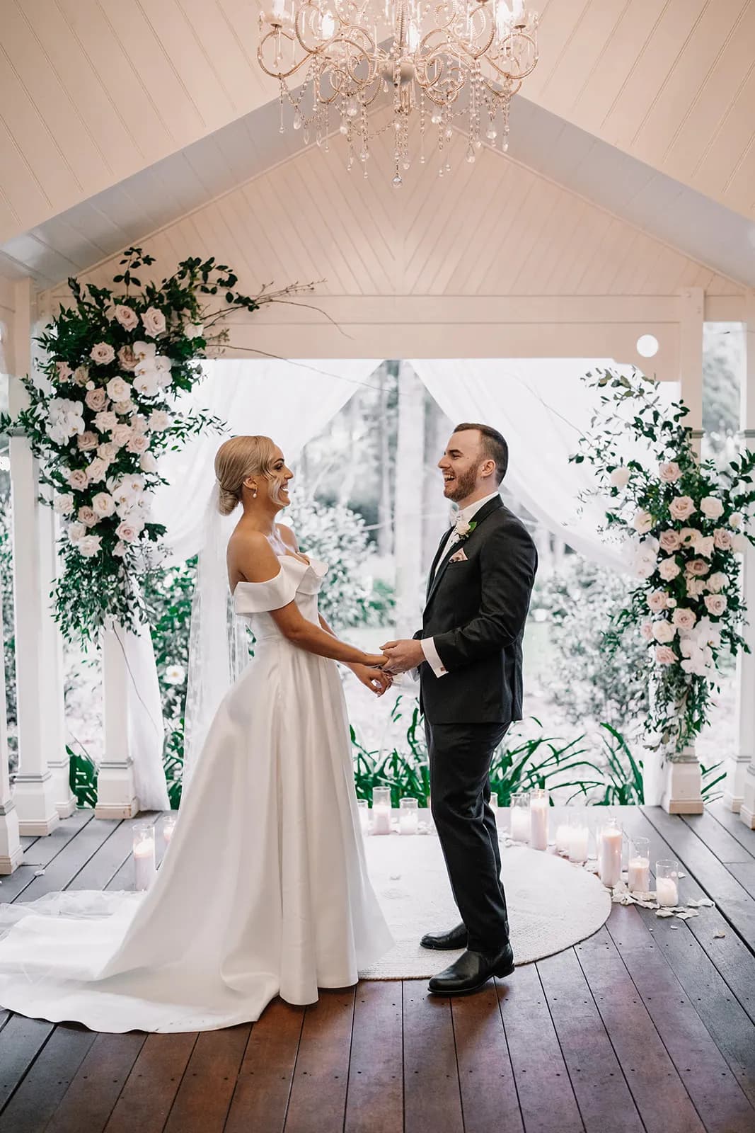 Bride and groom standing at altar holding hands