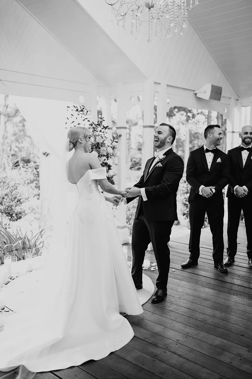 Bride and groom standing at altar holding hands