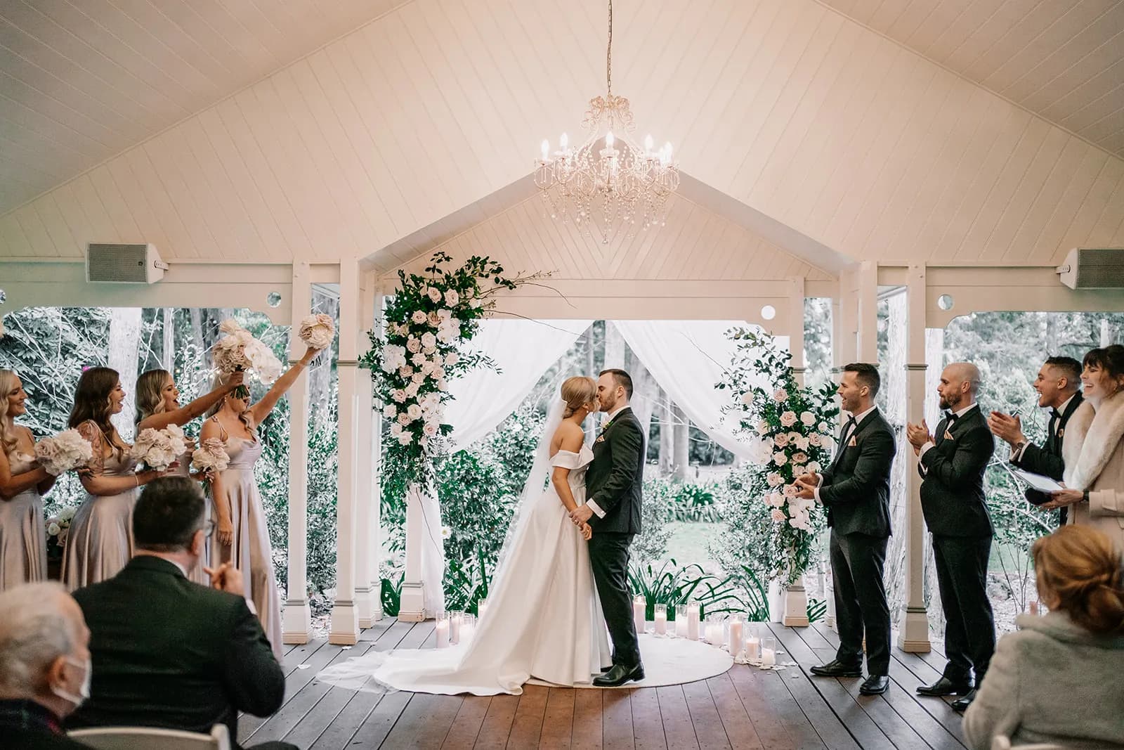 Bride and groom kissing at aisle