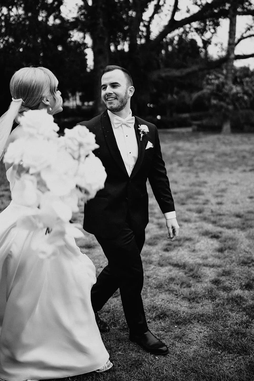 Bride and groom walking in gardens