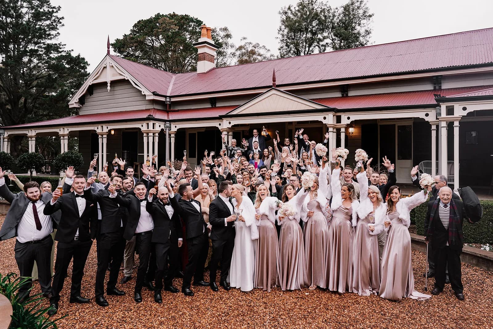 Wedding guests standing in front of homestead