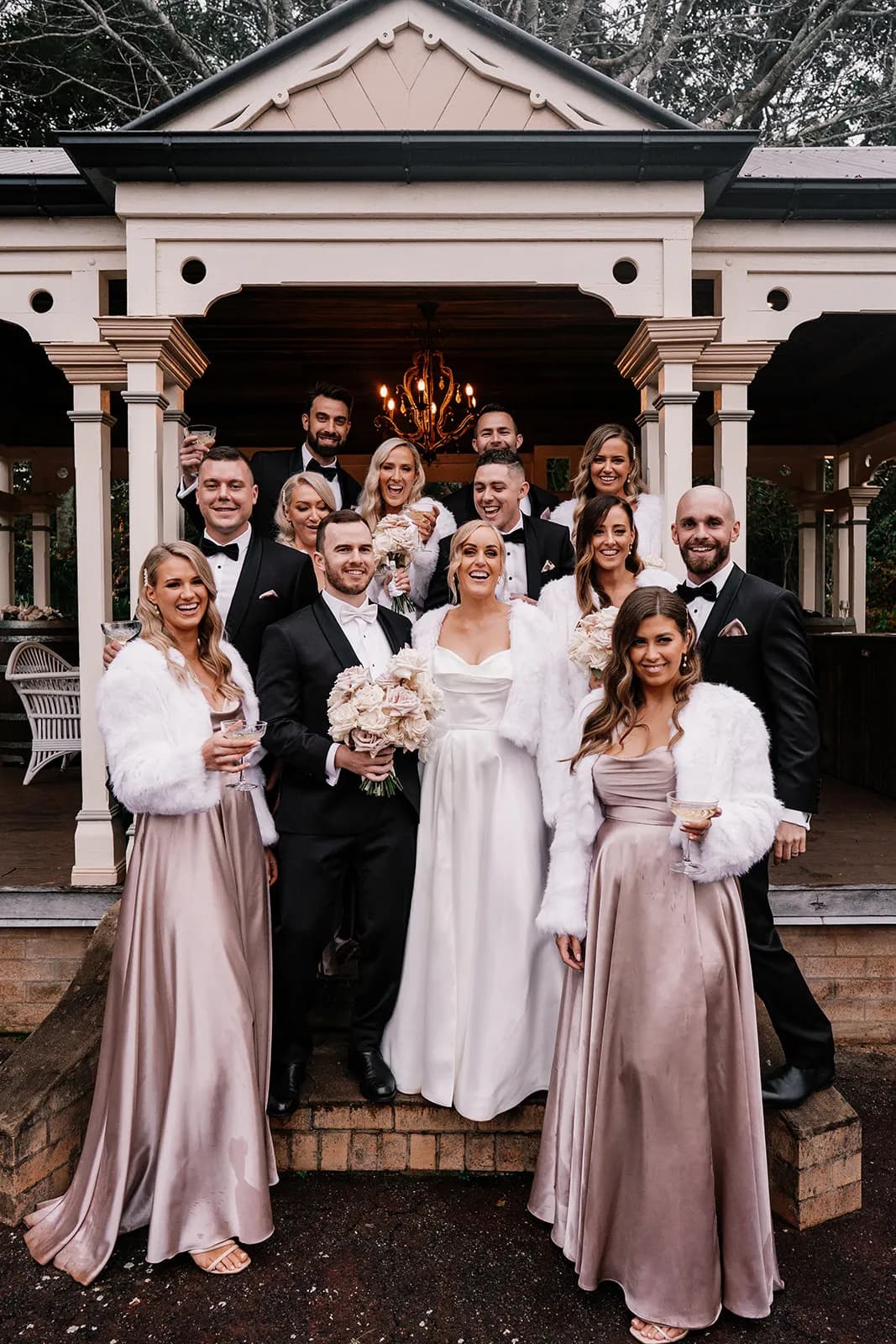 Bride and groom in front of tennis pavilion