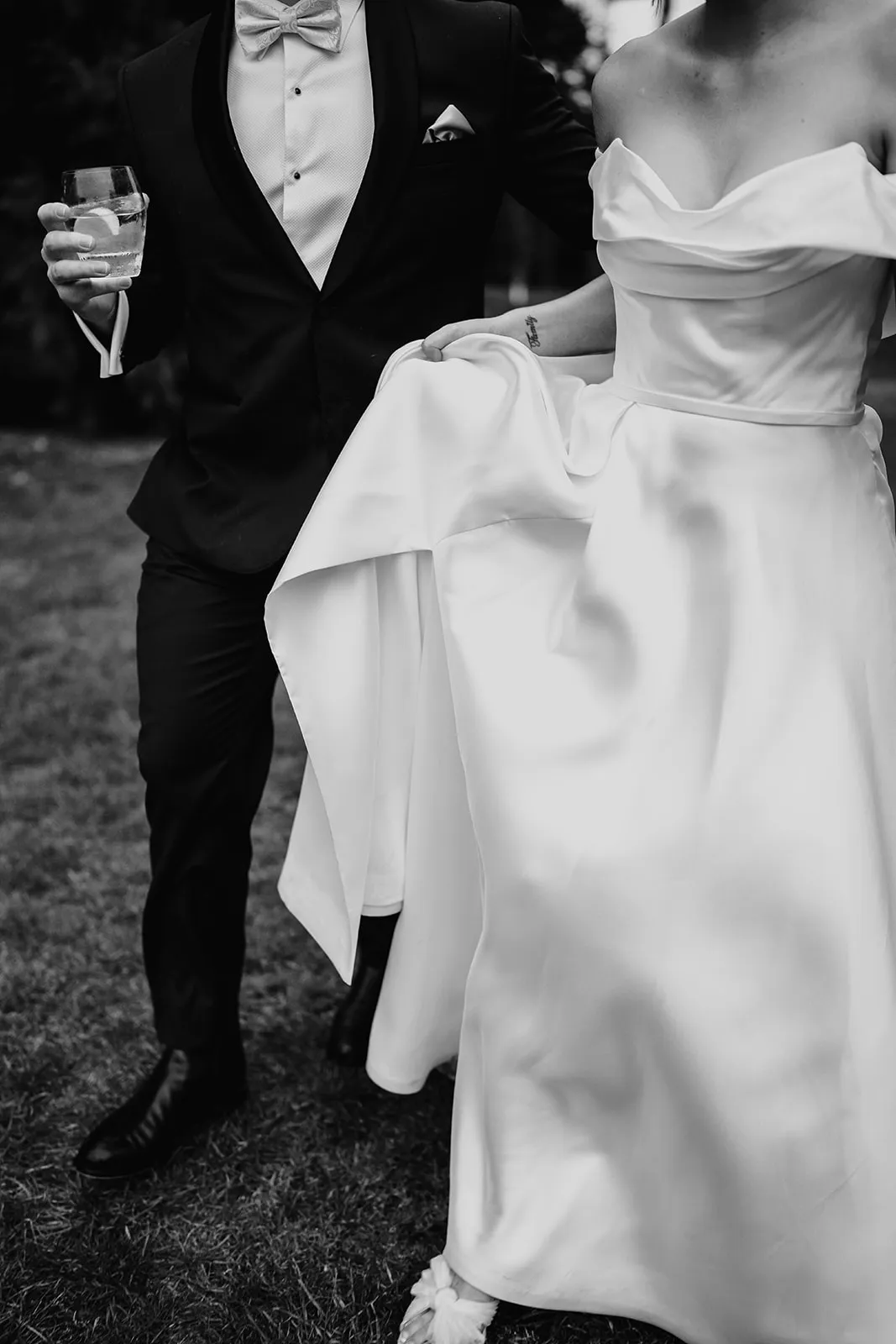 Bride and groom walking through gardens