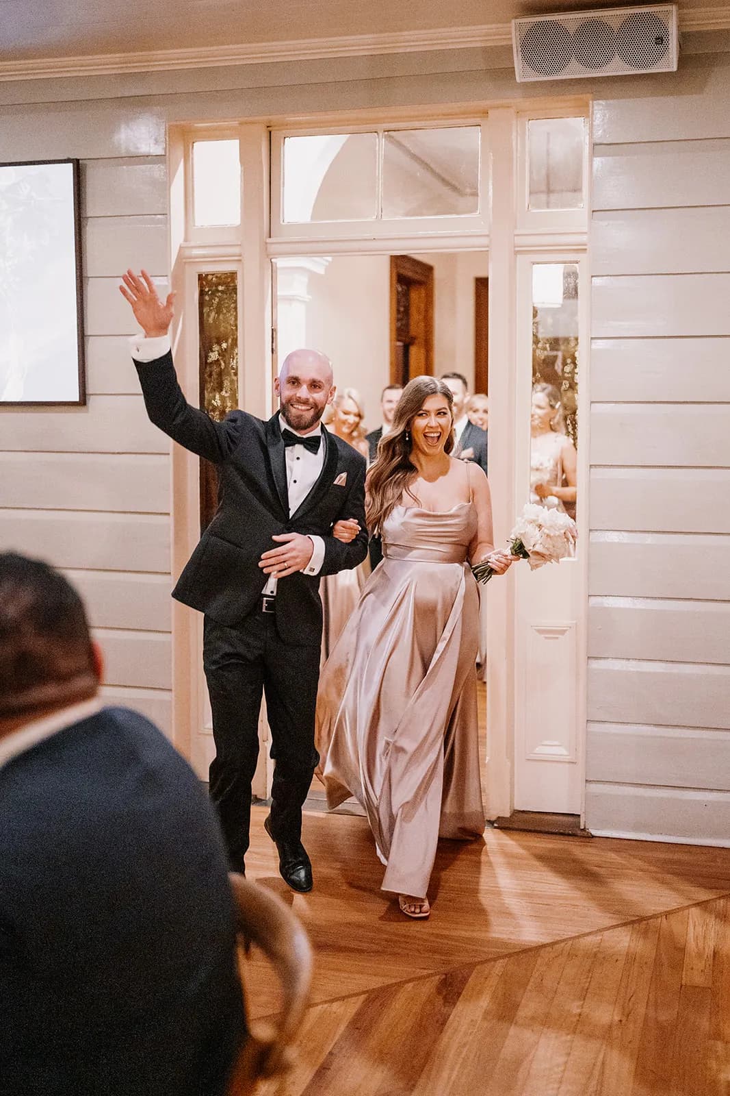 Wedding party walking into wedding reception