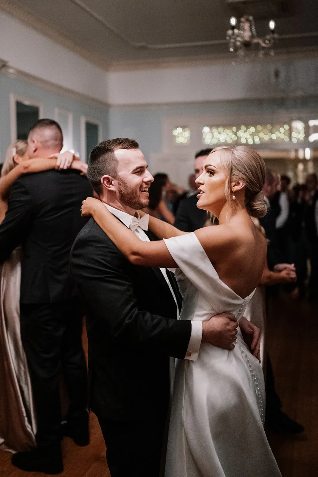 Bride and groom dancing in ballroom
