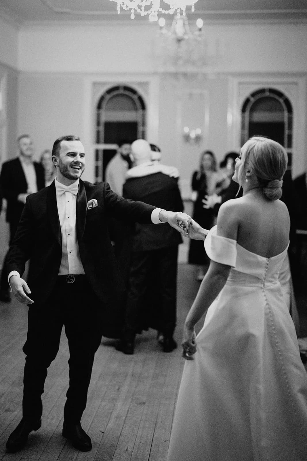 Bride and groom dancing in ballroom