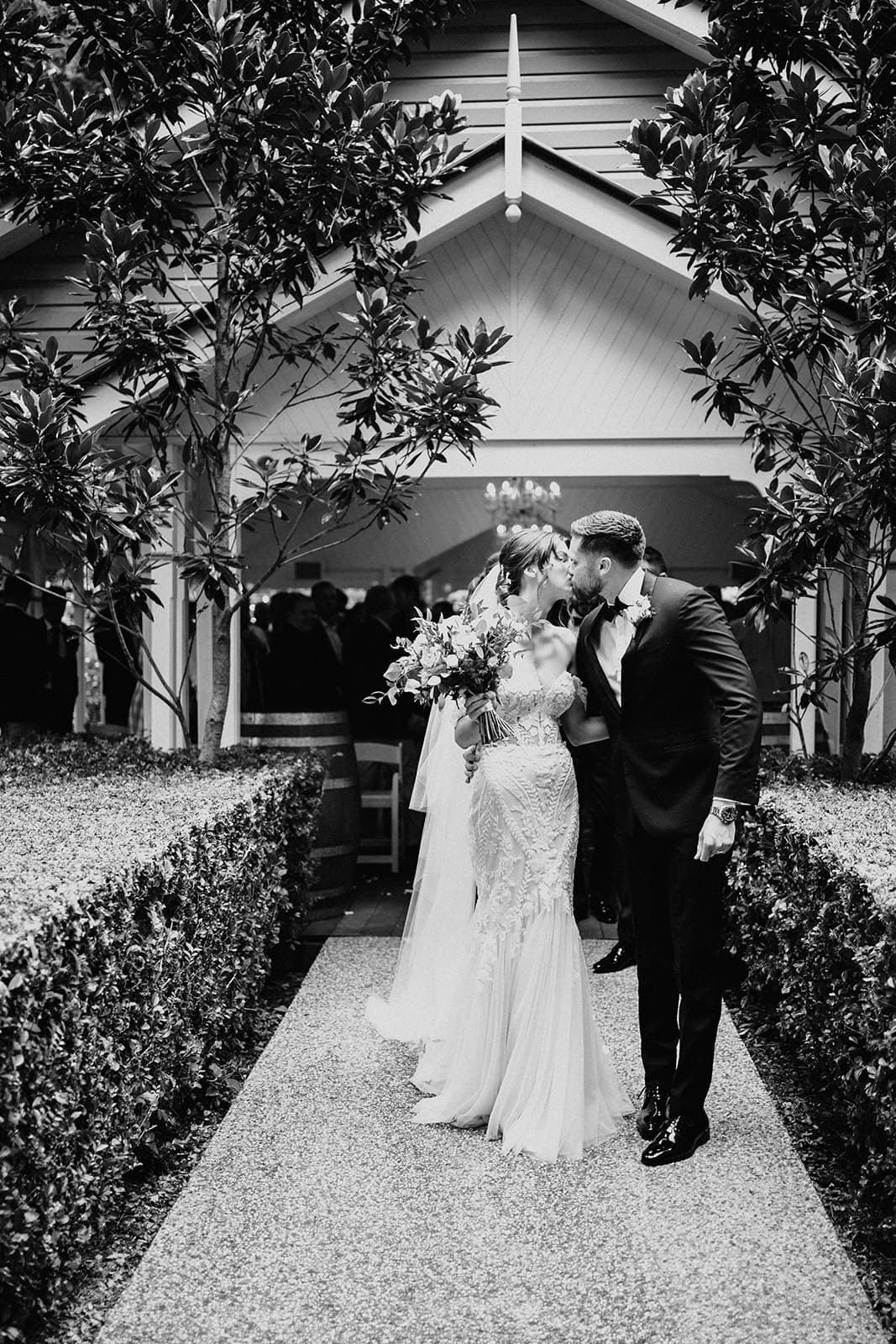 Bride and groom walking and kissing