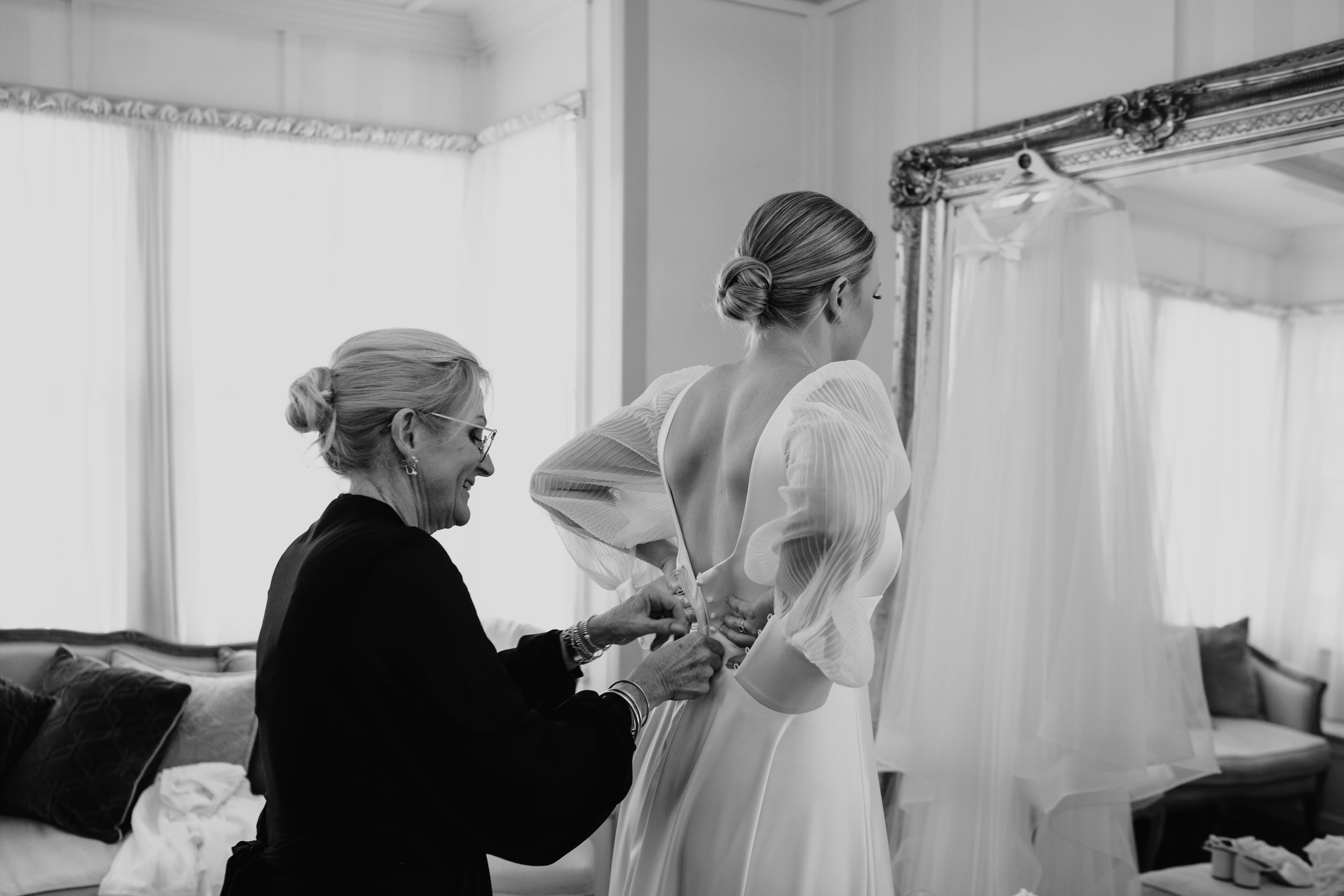Mother of bride doing up dress