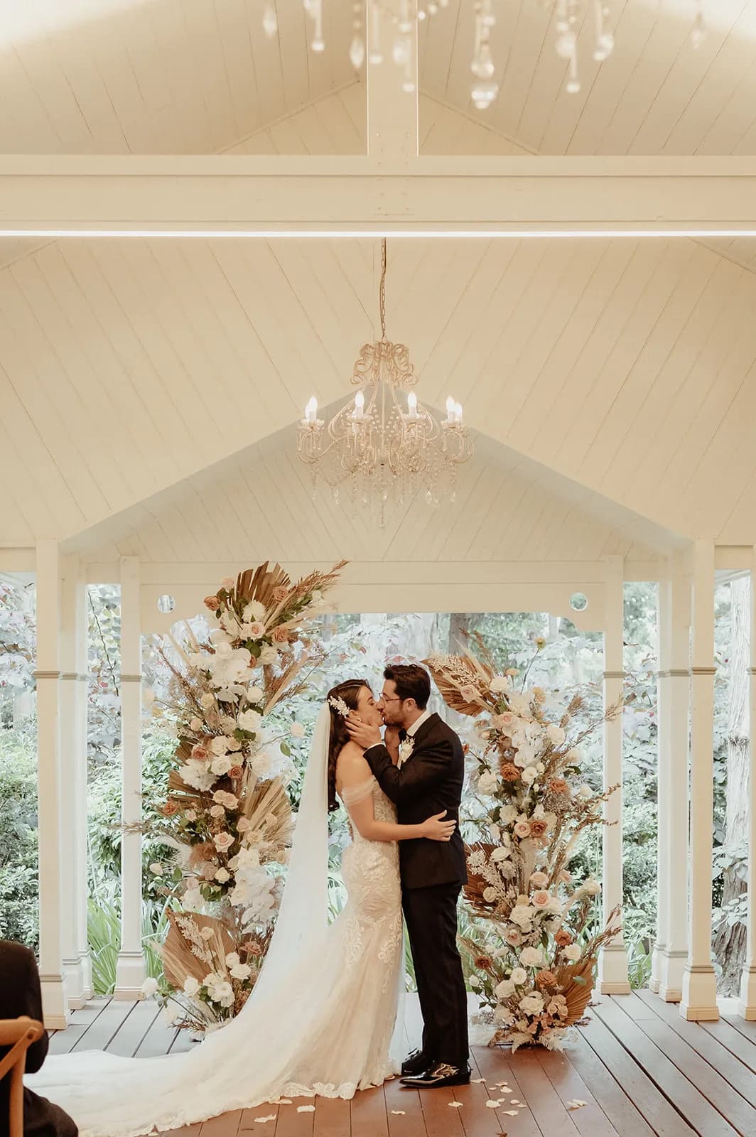 Bride and groom kissing at altar