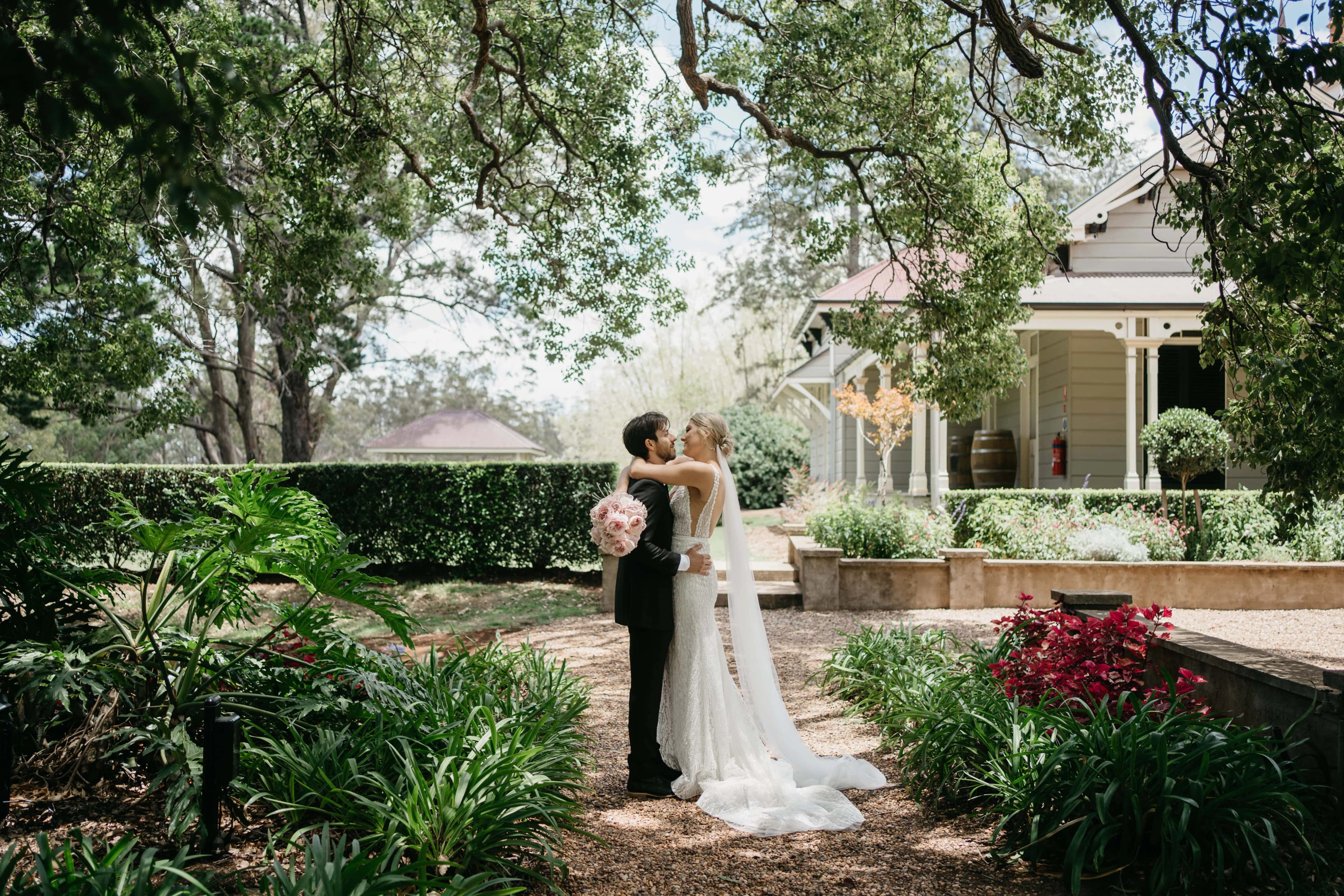 a happy couple embracing in the grounds at gabbinbar